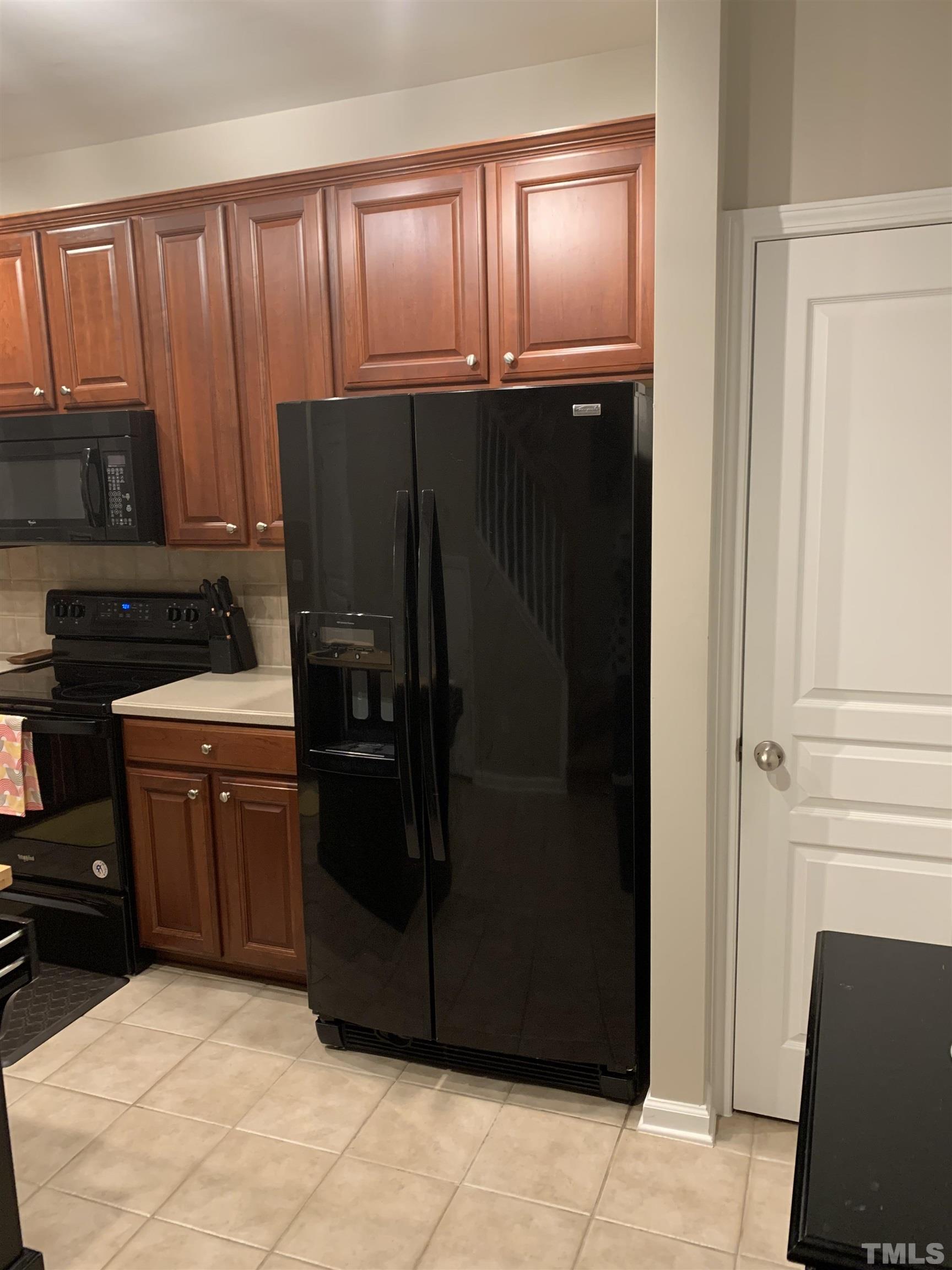 7845 Spungold Street Raleigh, NC 27617 - Photo 10 of 37 a kitchen with a refrigerator and a stove