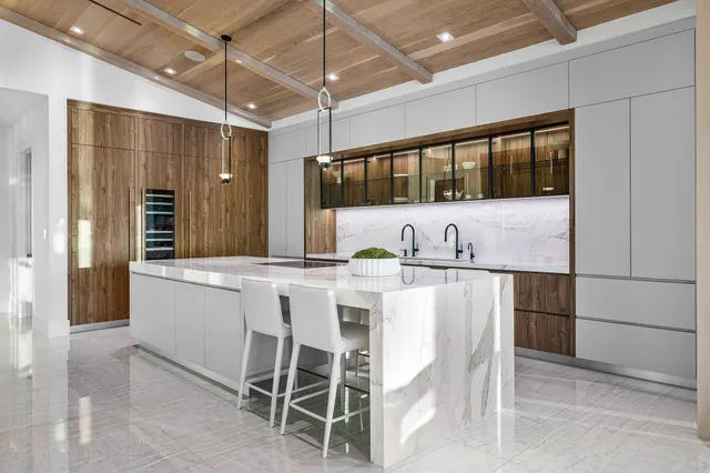 a living room with furniture a window and potted plants