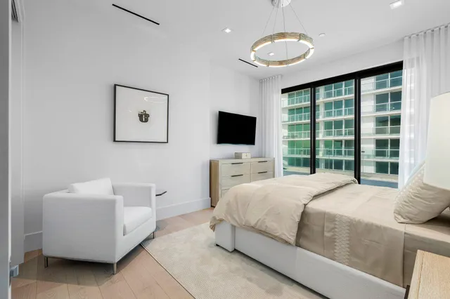 a living room with furniture a window and a potted plant