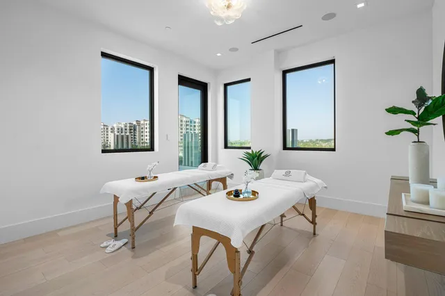 a view of a dining room with furniture large windows and wooden floor