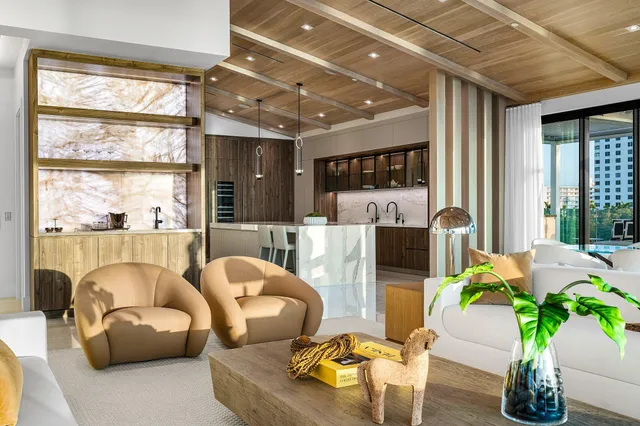 a kitchen with kitchen island a chandelier and refrigerator