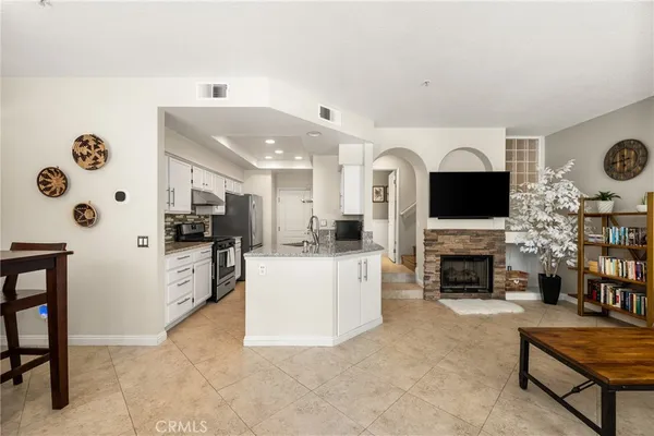 a living room with fireplace furniture and a flat screen tv
