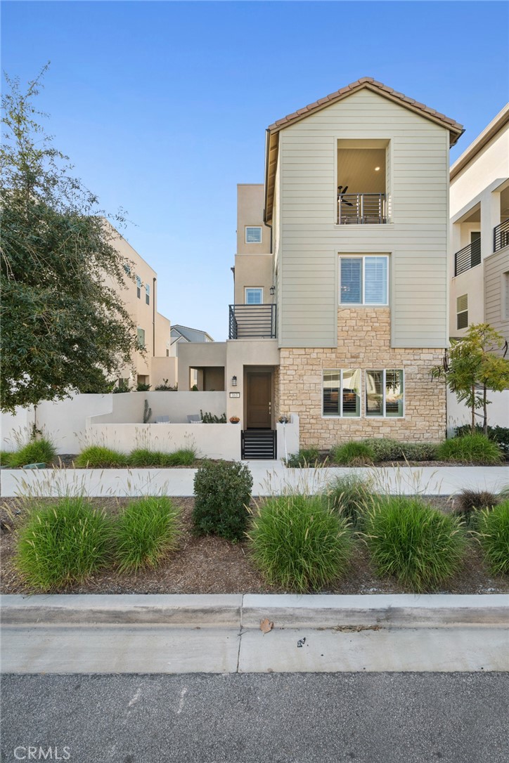 163 Crossover Irvine, CA 92618 - Photo 1 of 1 a front view of a building with a garden and plants