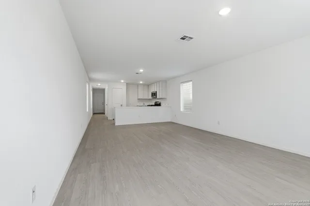 a view of a kitchen with a sink and cabinets