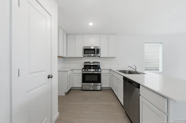 a kitchen with granite countertop a stove and a sink