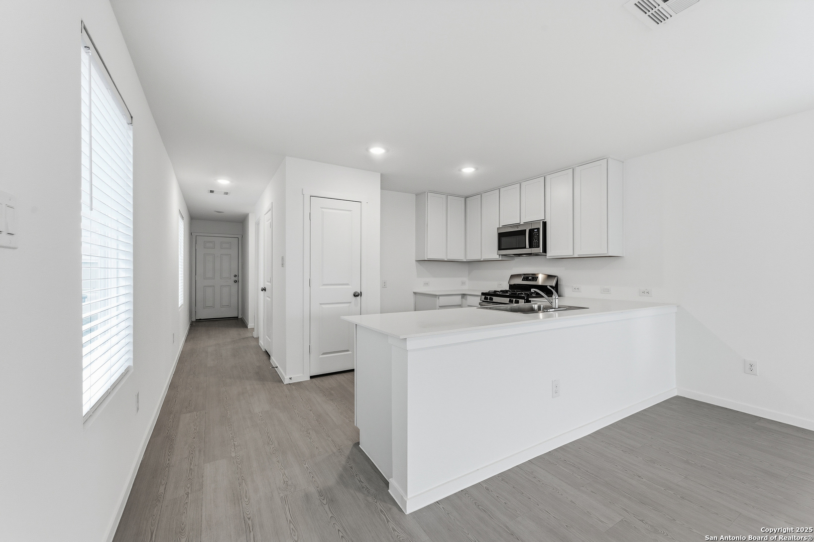 11814 Bluebell Ridge Converse, TX 78109 - Photo 6 of 20 a view of a kitchen with a sink a refrigerator and window