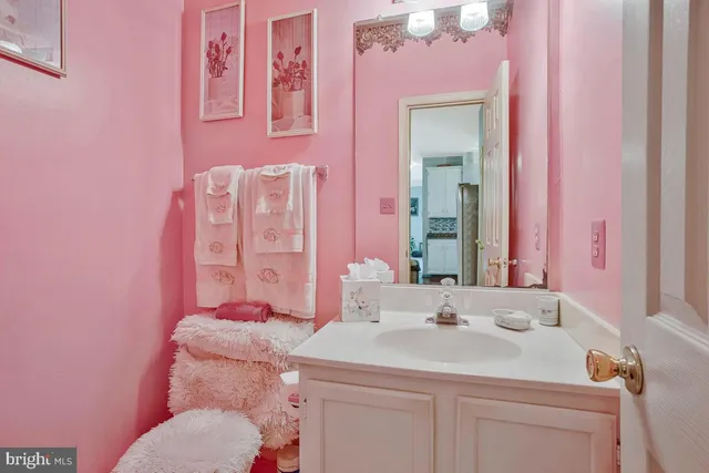 a bathroom with a sink vanity granite and toilet