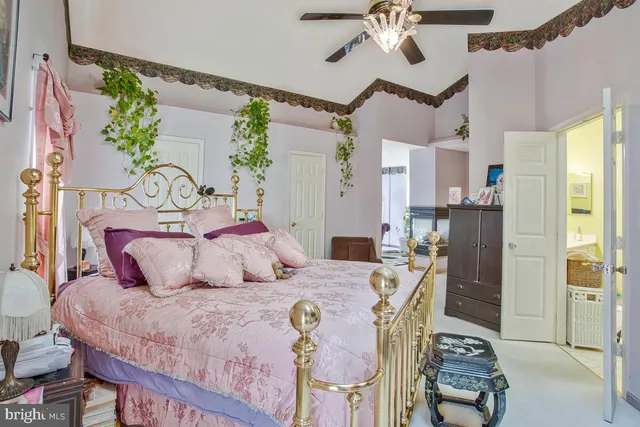 a bedroom with a large bed and a chandelier