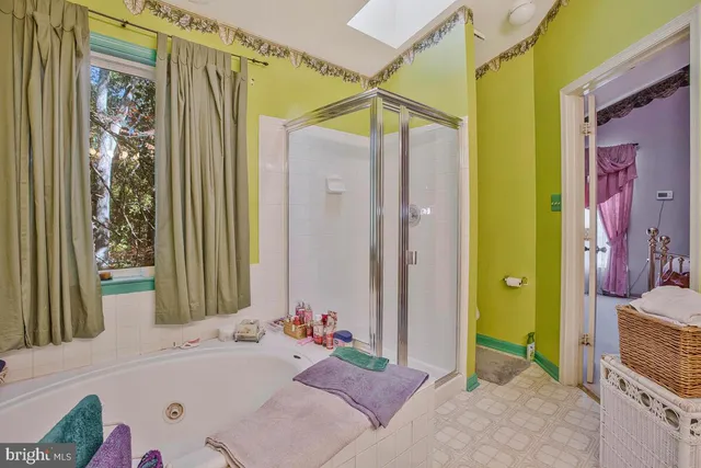 a bathroom with a tub sink and a mirror