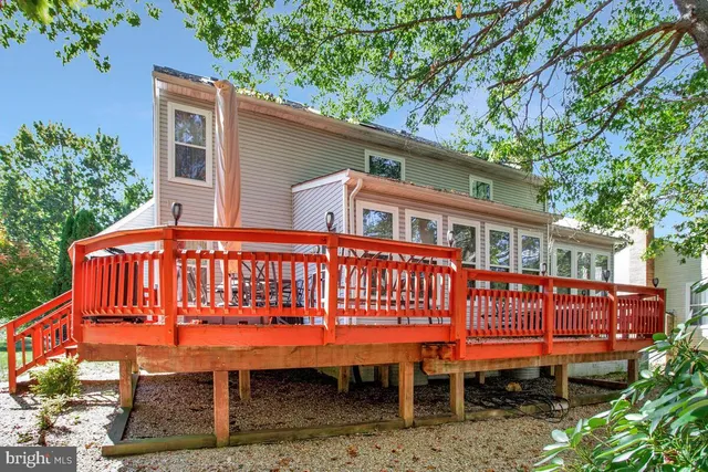 a view of a chairs and bench in the backyard
