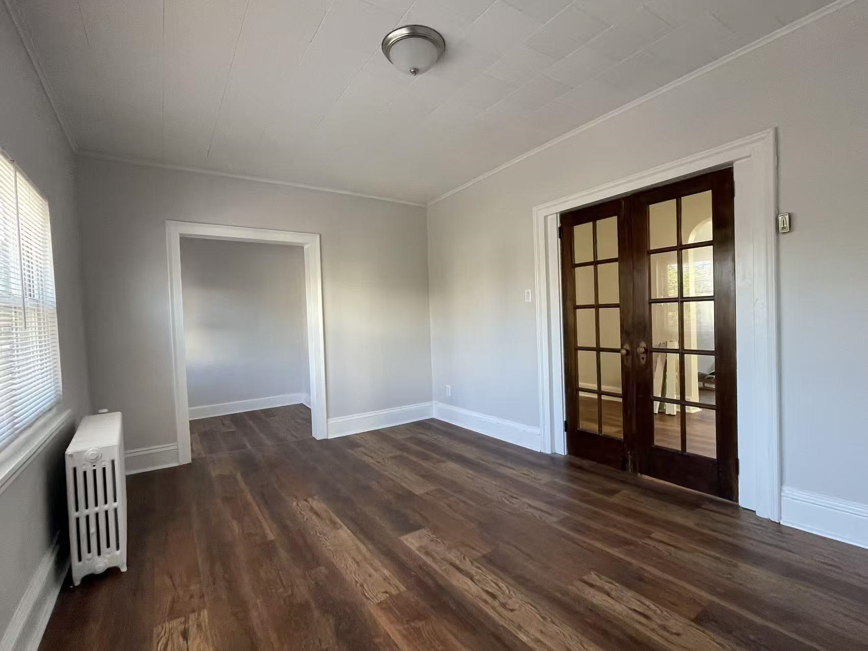 109 70th Street, Unit 2 Guttenberg, NJ 07093 - Photo 11 of 17 an empty room with wooden floor and windows