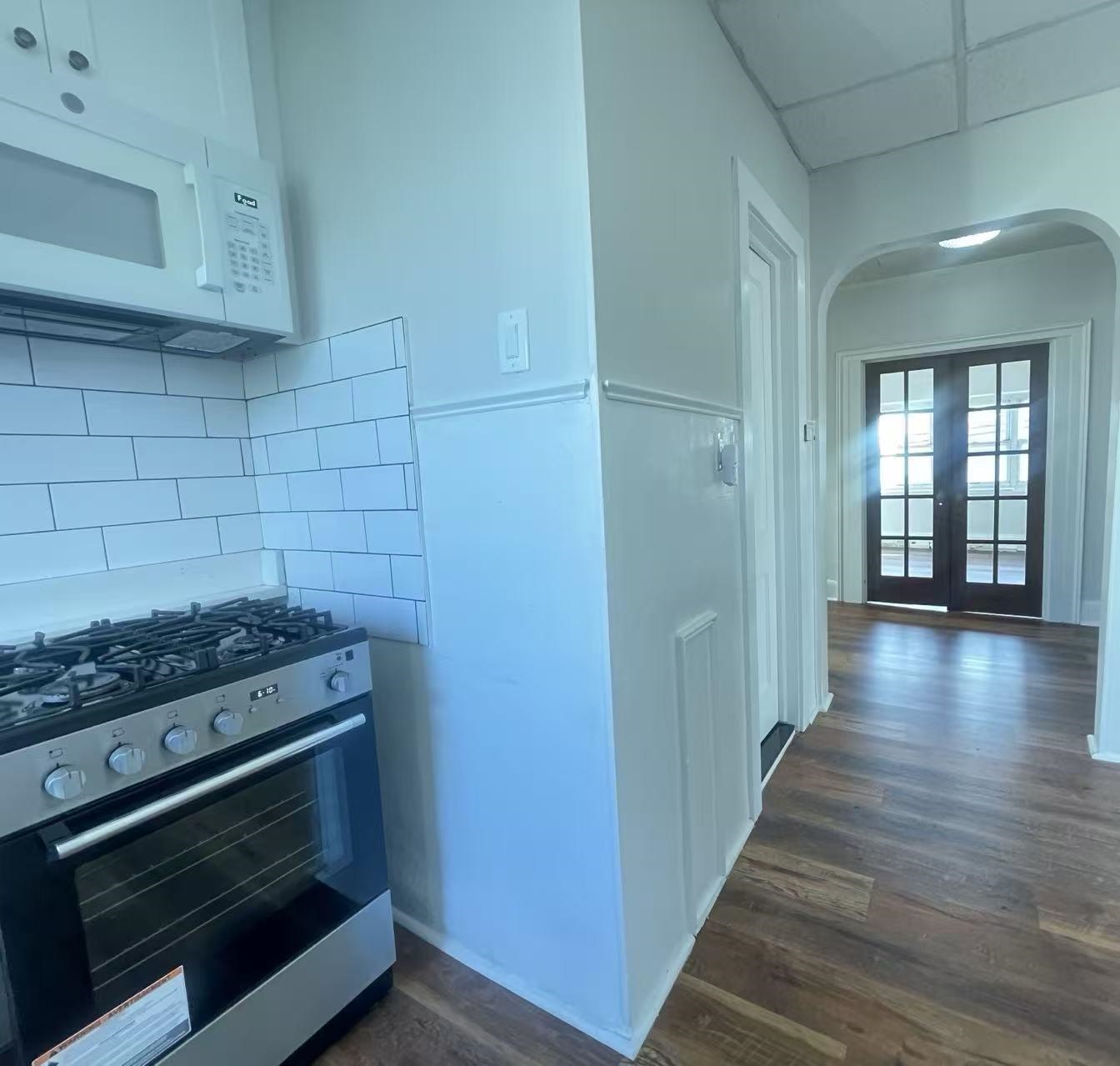 109 70th Street, Unit 2 Guttenberg, NJ 07093 - Photo 5 of 17 a kitchen with a stove and a wooden floor