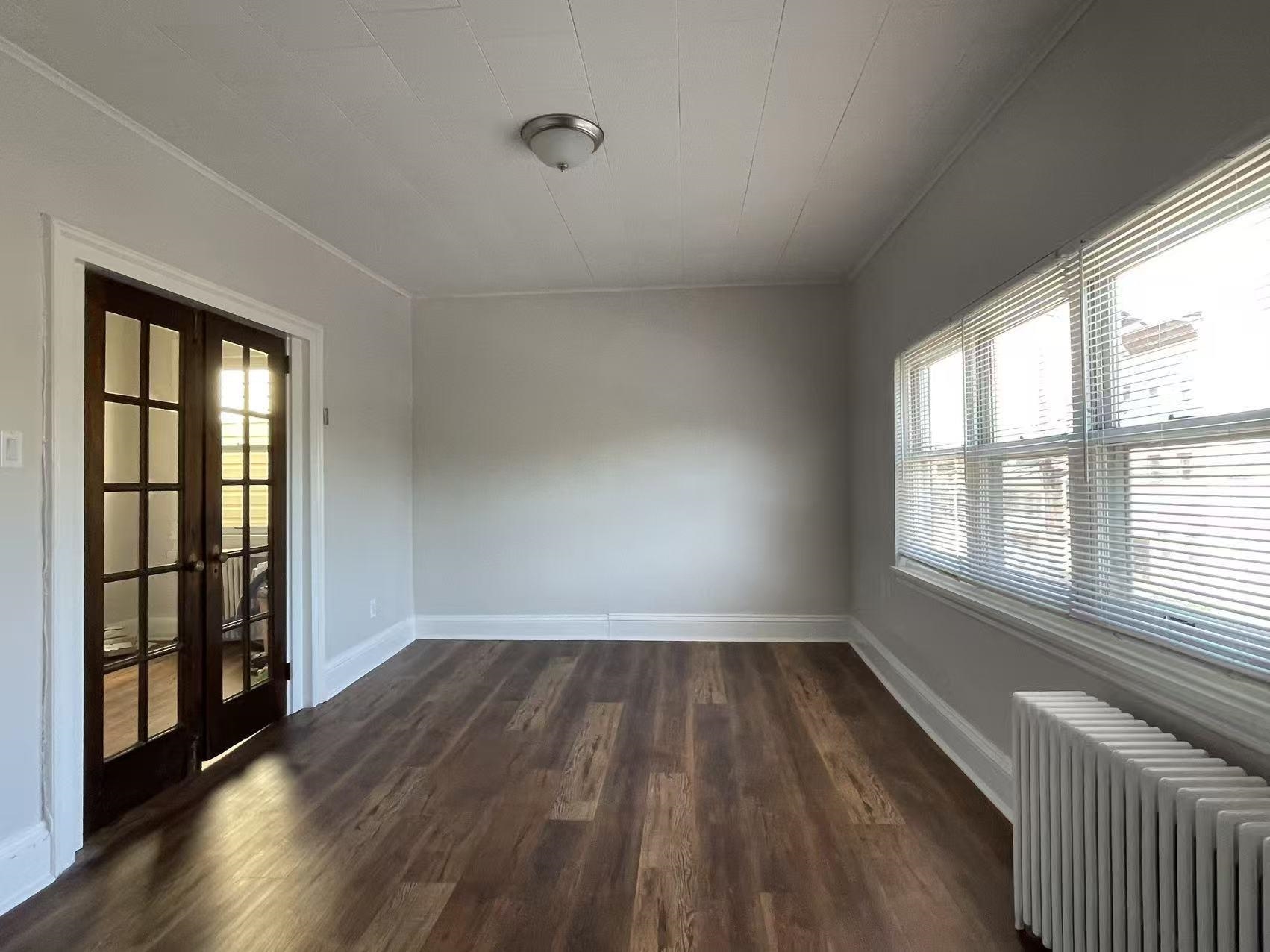109 70th Street, Unit 2 Guttenberg, NJ 07093 - Photo 7 of 17 wooden floor in an empty room with a window