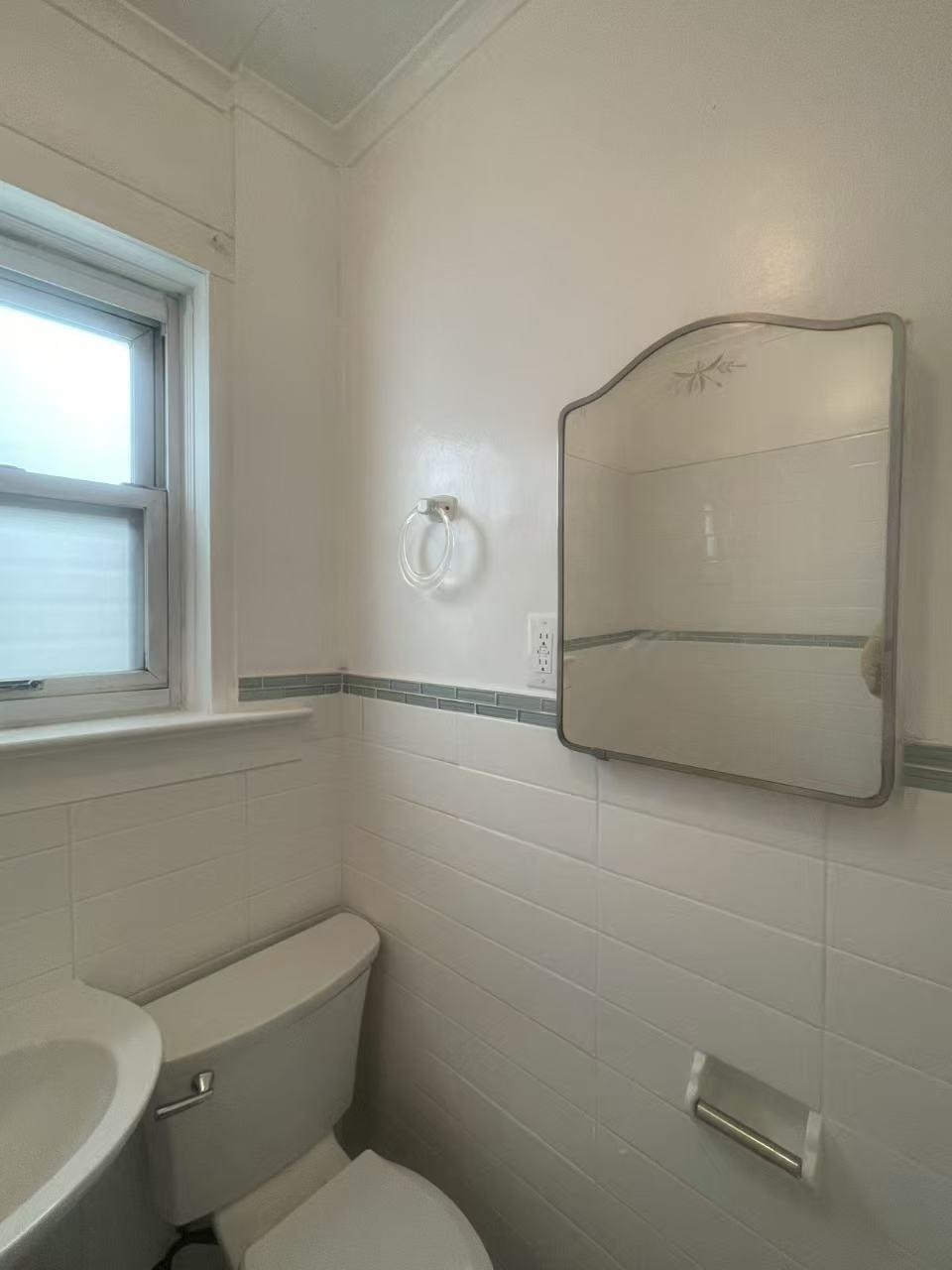 109 70th Street, Unit 2 Guttenberg, NJ 07093 - Photo 8 of 17 a white toilet sitting next to a bathroom sink