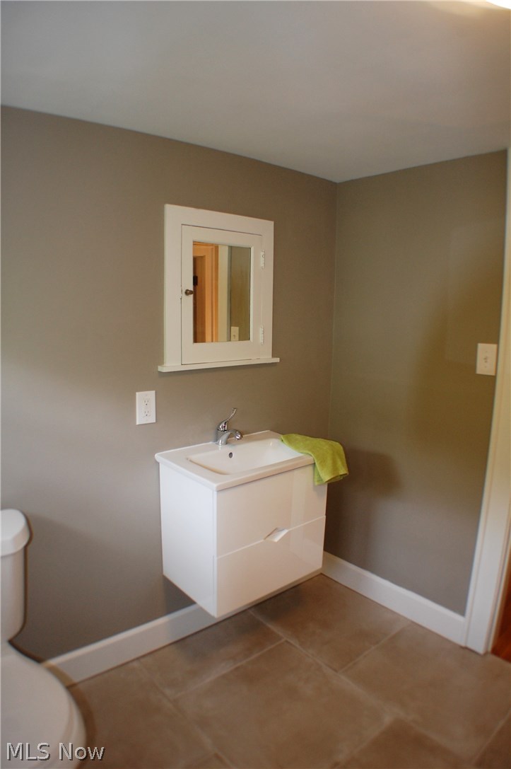 2277 Lamberton Road Cleveland, OH 44118 - Photo 26 of 34 Sink in 3rd floor bathroom--modern meets classic in this lovely bath with it's large format tile ad wall hung sink, this bath has a claw foot tub too.