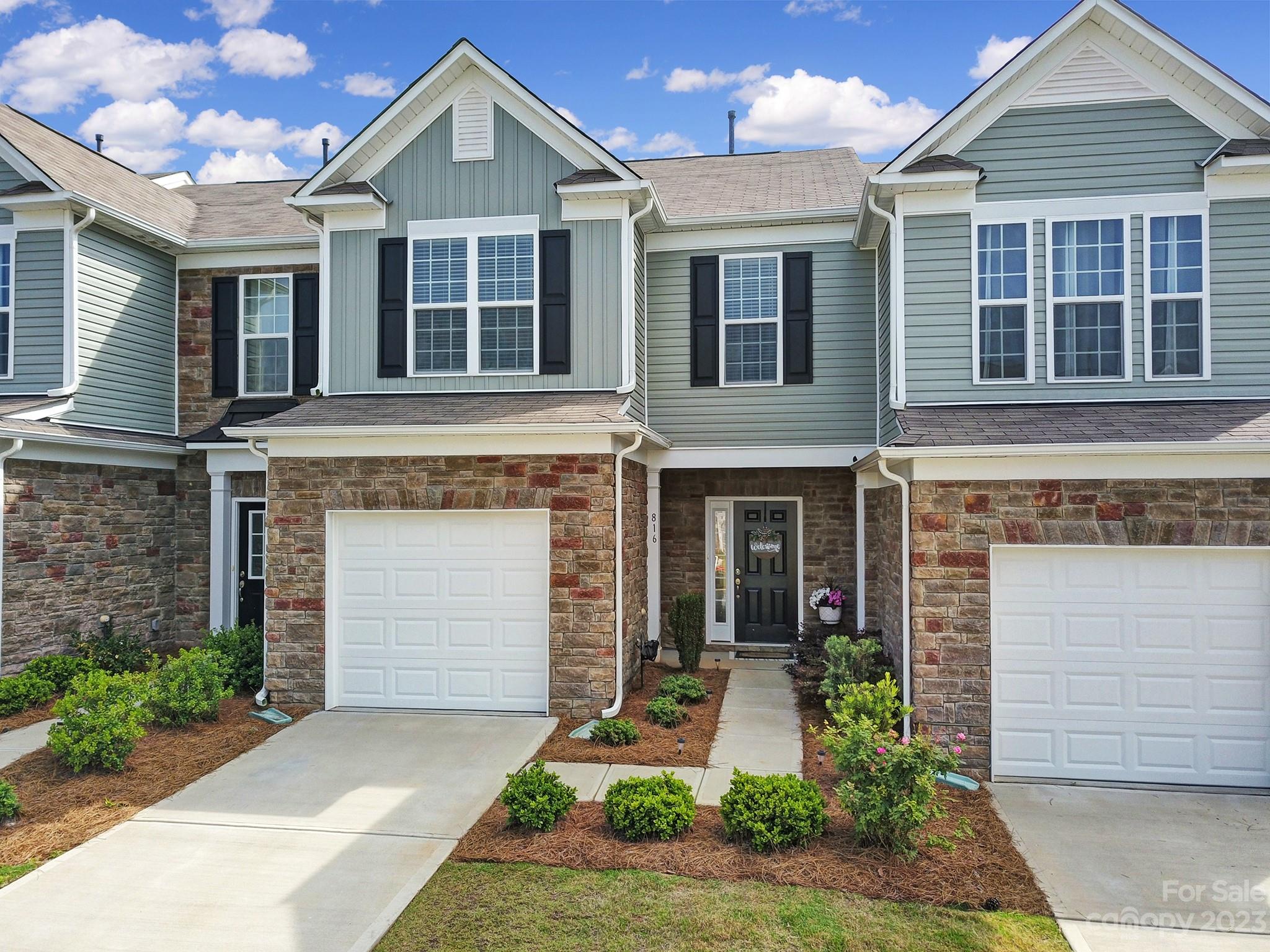 a front view of a house with garden