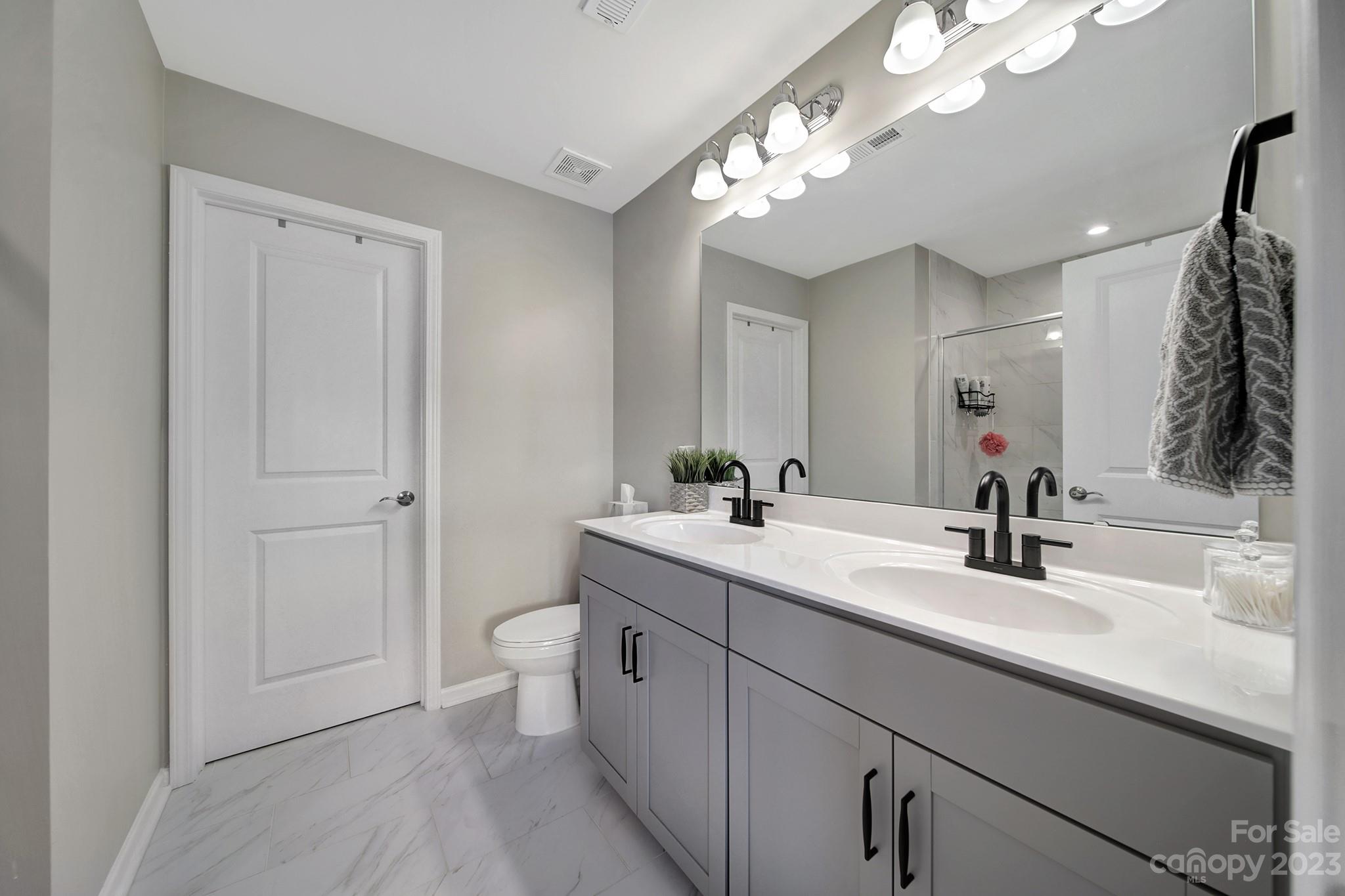 816 Canoe Song Road Fort Mill, SC 29708 - Photo 13 of 24 a bathroom with a double vanity sink mirror and toilet