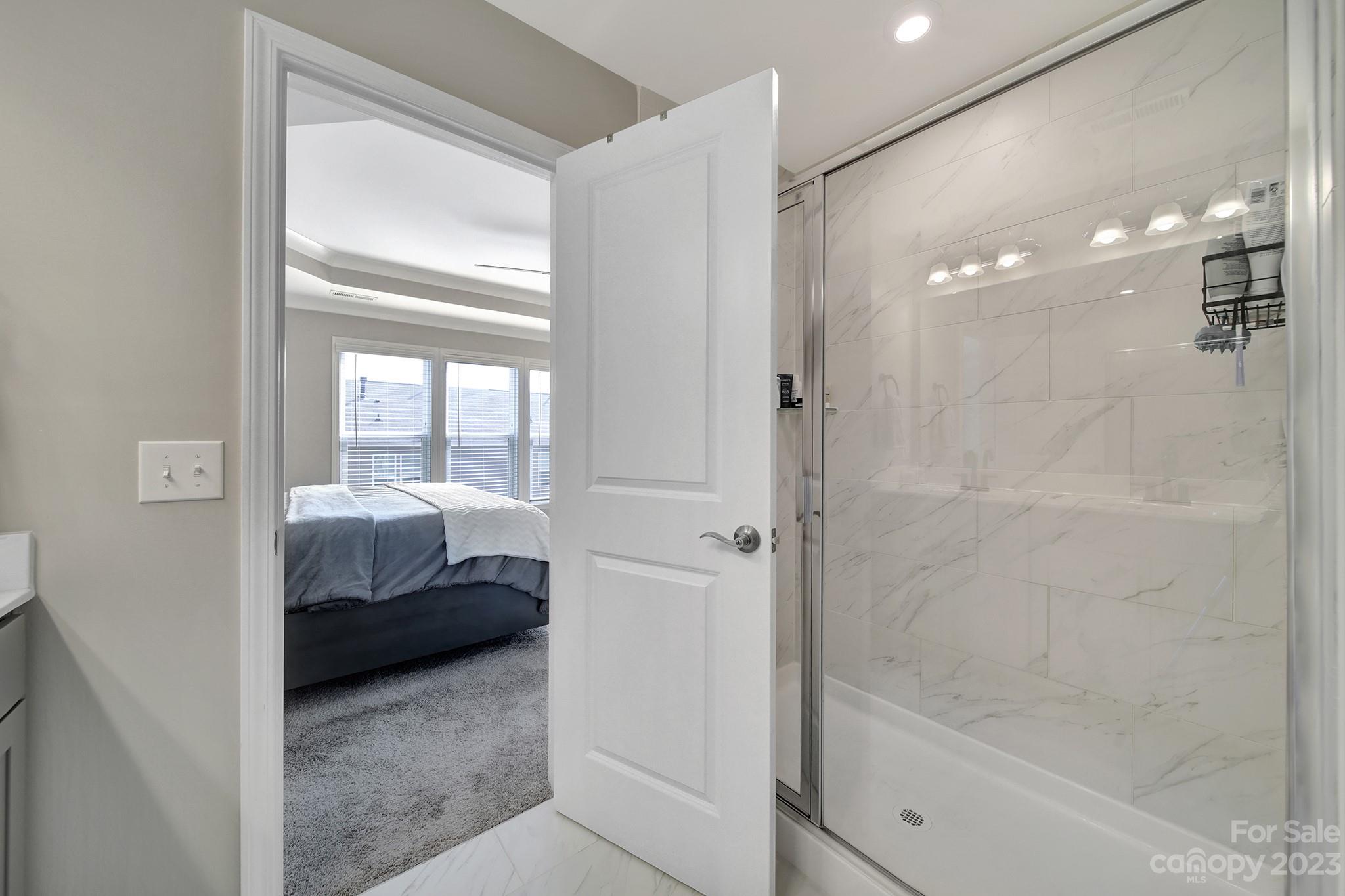 816 Canoe Song Road Fort Mill, SC 29708 - Photo 14 of 24 a en suite bathroom with a tub shower and bedroom