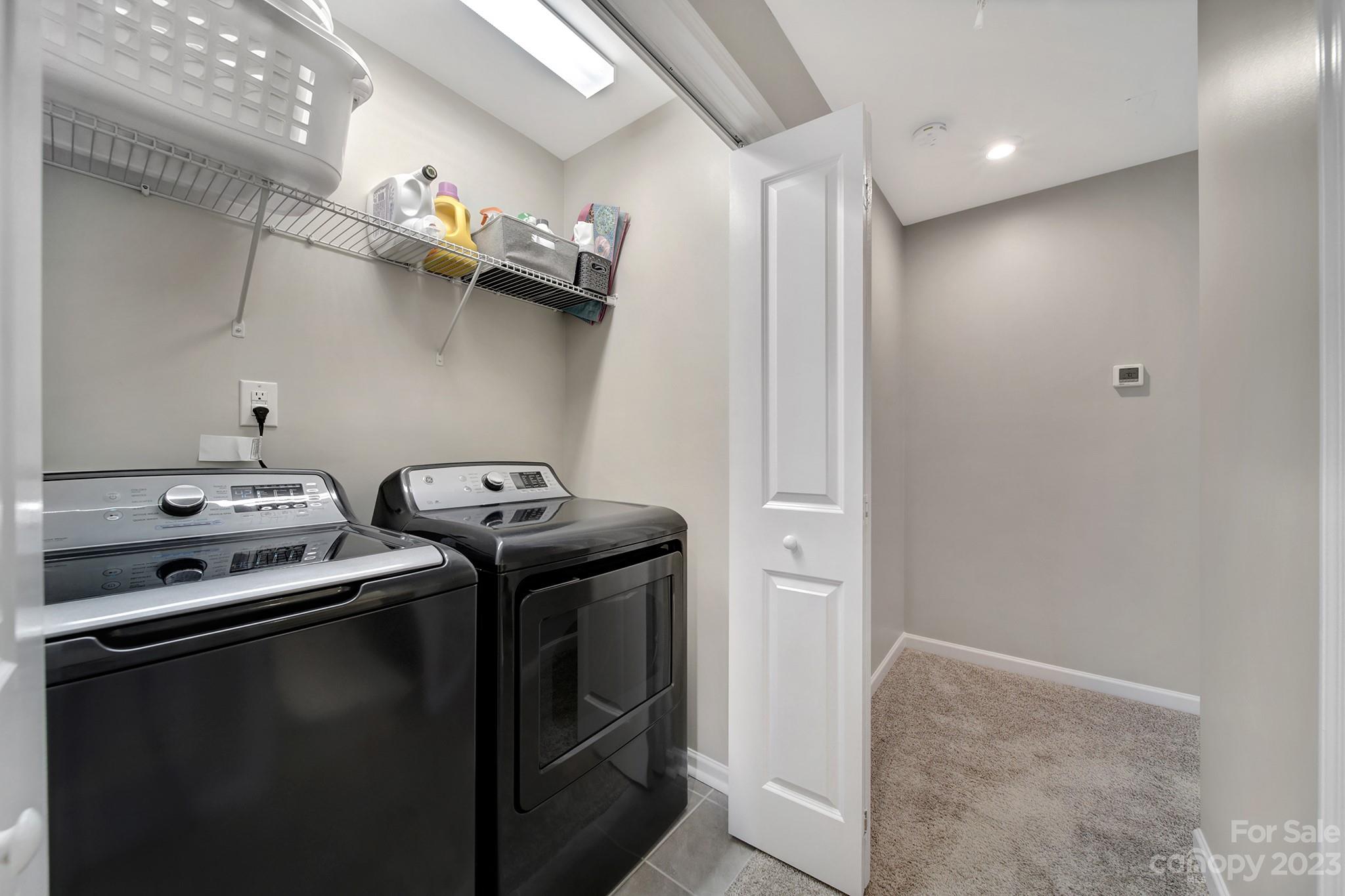 816 Canoe Song Road Fort Mill, SC 29708 - Photo 15 of 24 a close view of a stove and a utility room with dryer and washer