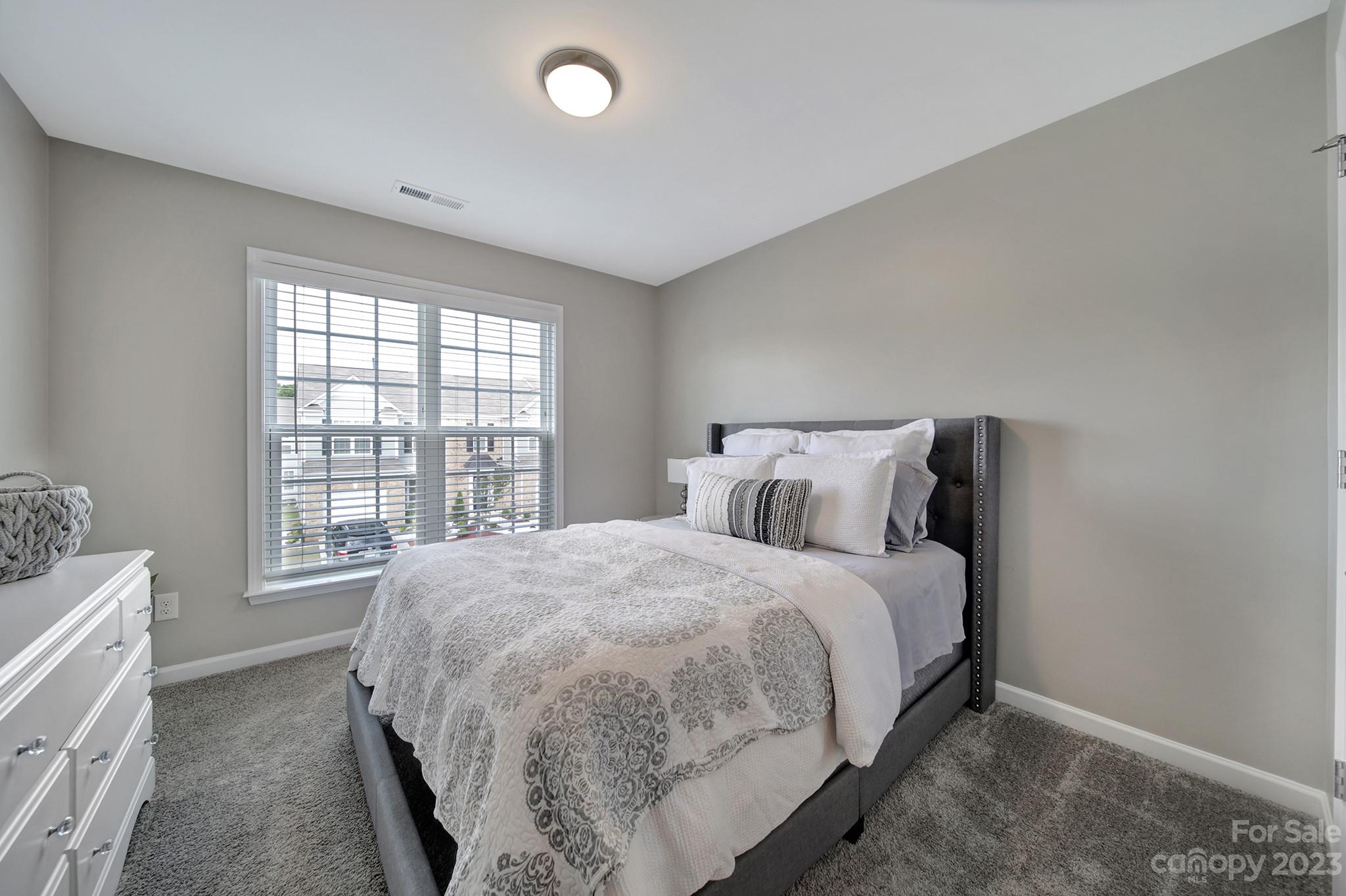 816 Canoe Song Road Fort Mill, SC 29708 - Photo 16 of 24 a bed sitting in a bedroom next to a window