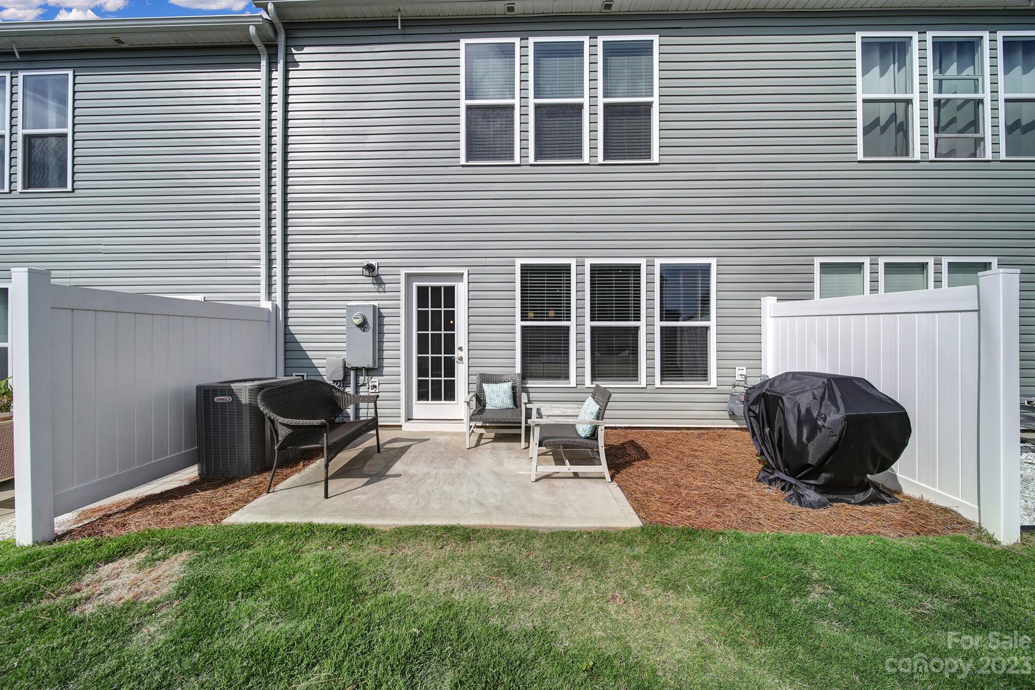 816 Canoe Song Road Fort Mill, SC 29708 - Photo 21 of 24 a backyard of a house with yard and outdoor seating