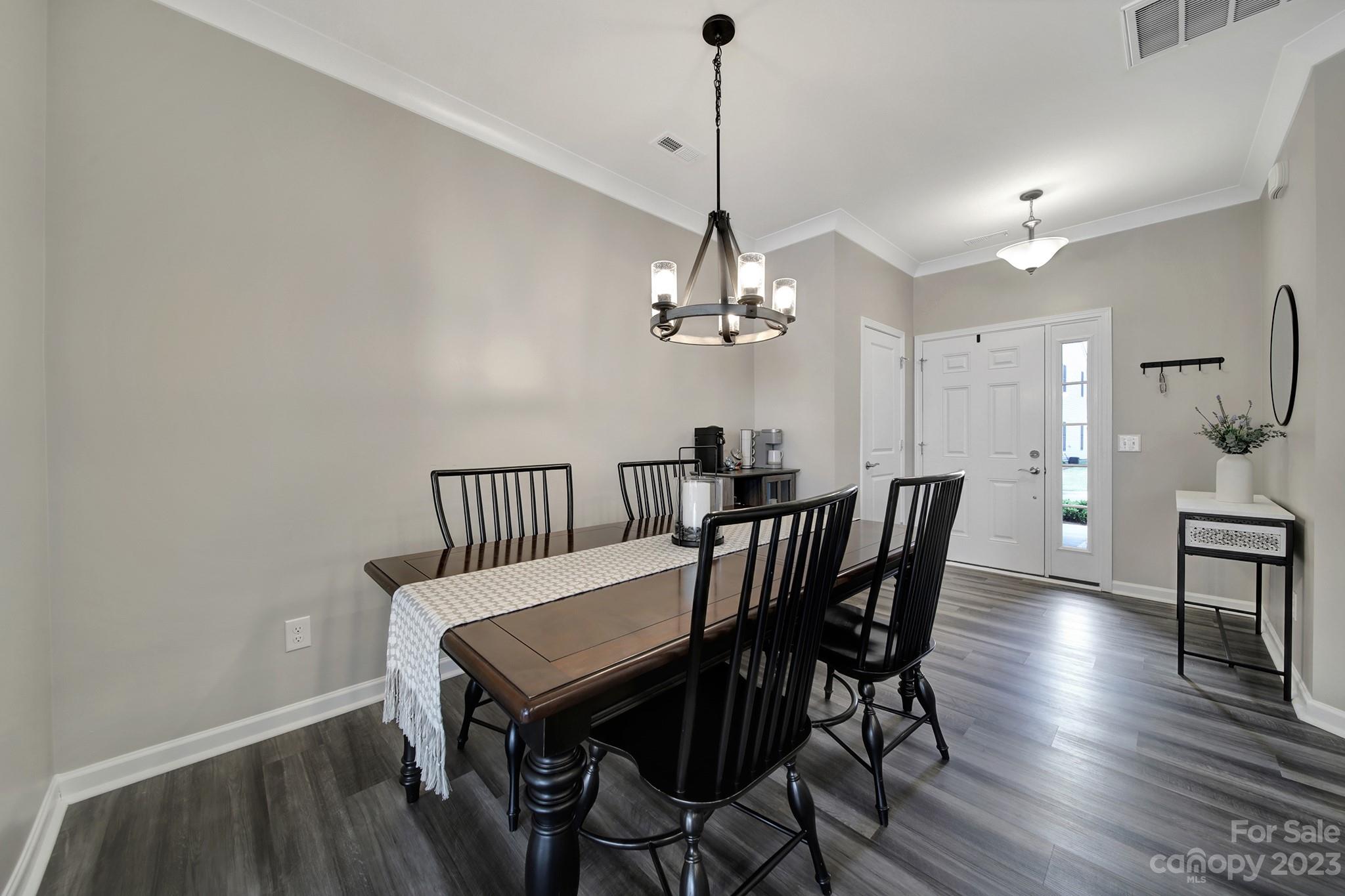 816 Canoe Song Road Fort Mill, SC 29708 - Photo 4 of 24 a view of a dining room with furniture a chandelier and wooden floor