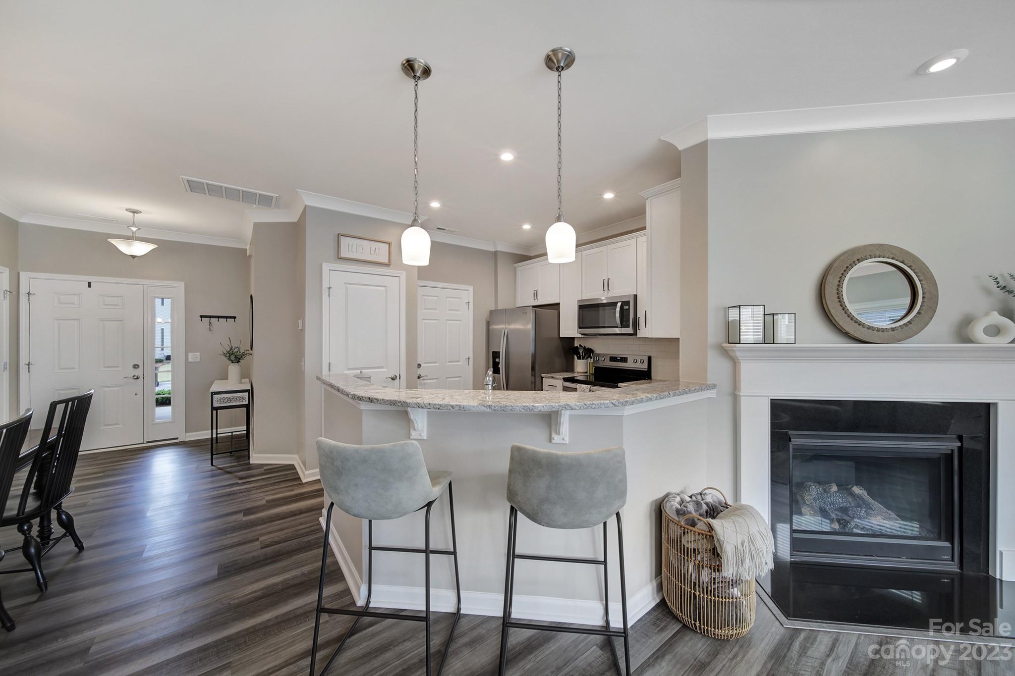 816 Canoe Song Road Fort Mill, SC 29708 - Photo 7 of 24 a open kitchen view with fireplace a sink and a chandelier