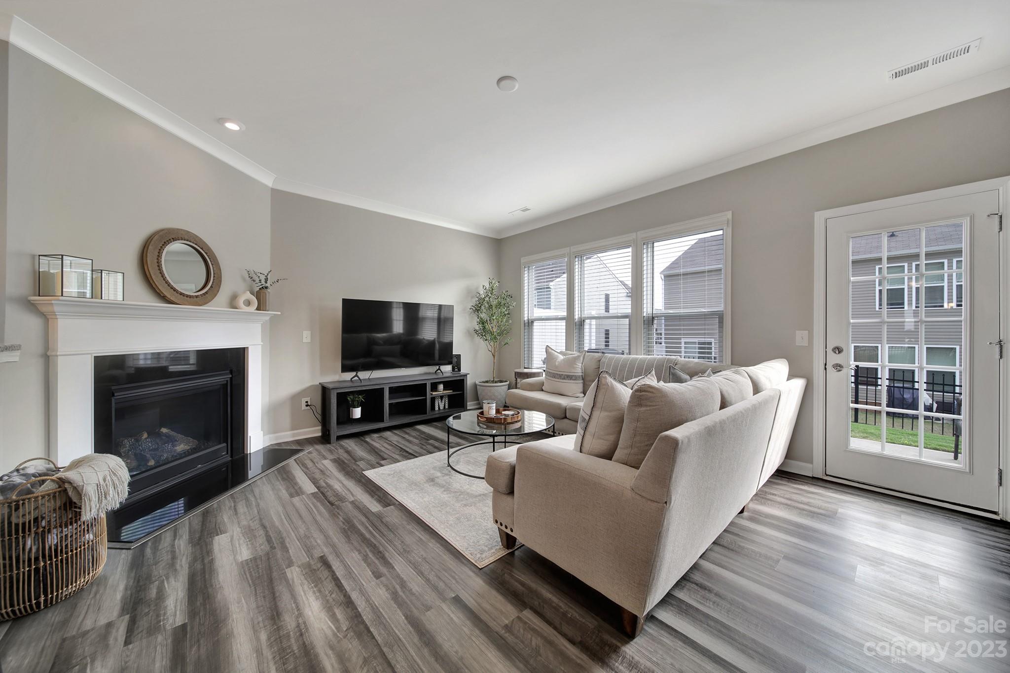 816 Canoe Song Road Fort Mill, SC 29708 - Photo 8 of 24 a living room with furniture a flat screen tv and a fireplace