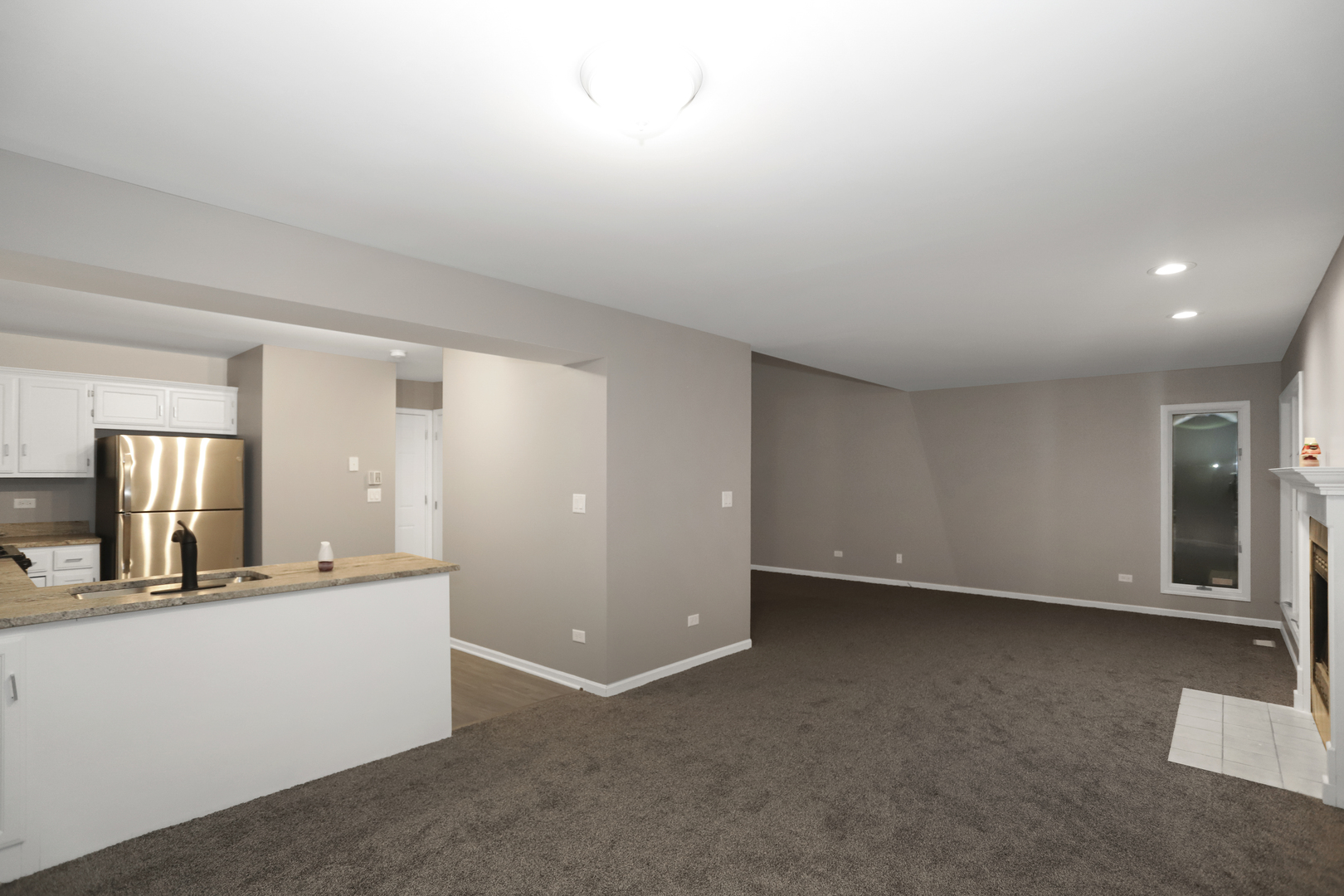 100 Ravinia Drive Shorewood, IL 60404 - Photo 11 of 33 an empty room with a kitchen and a sink