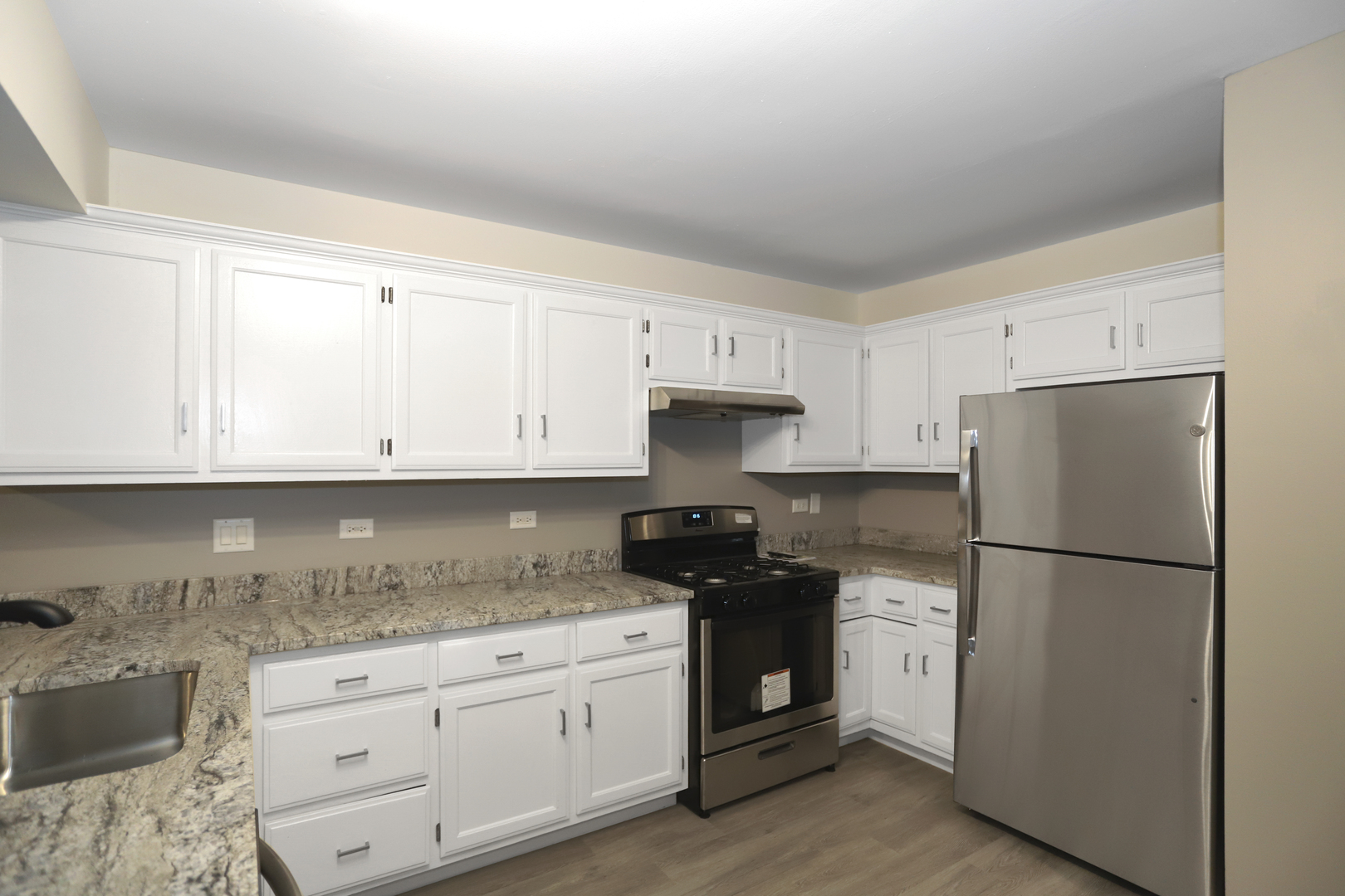 100 Ravinia Drive Shorewood, IL 60404 - Photo 15 of 33 a kitchen with granite countertop white cabinets and refrigerator