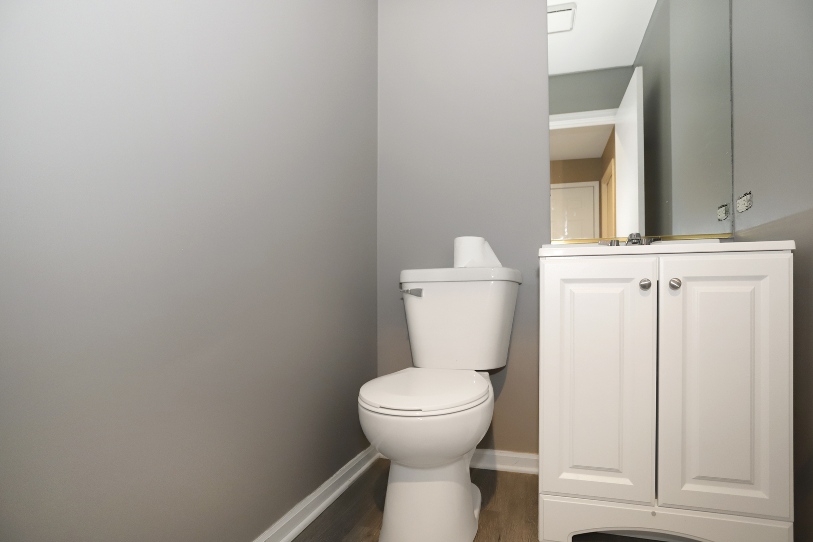 100 Ravinia Drive Shorewood, IL 60404 - Photo 17 of 33 a white toilet sitting next to a bathroom sink