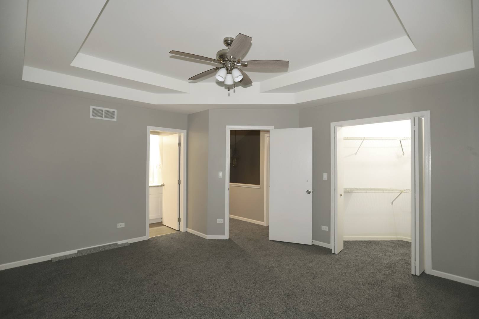 100 Ravinia Drive Shorewood, IL 60404 - Photo 20 of 33 an empty room with chandelier fan and windows