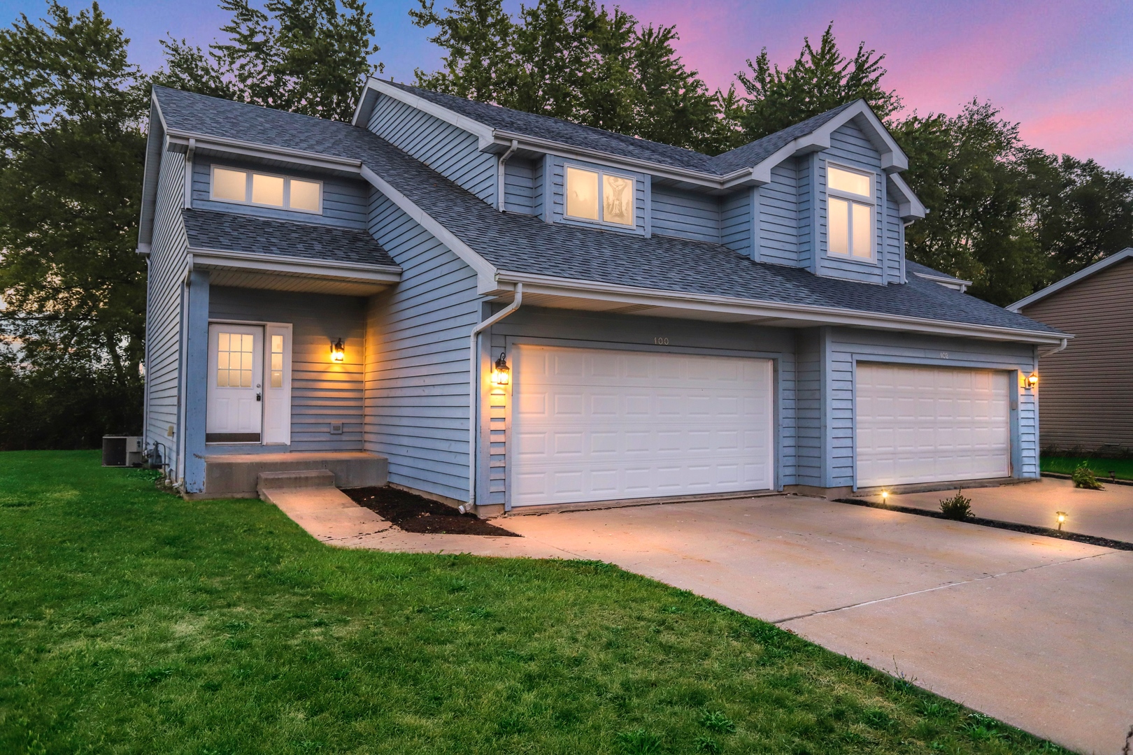100 Ravinia Drive Shorewood, IL 60404 - Photo 2 of 33 a front view of a house with a yard and garage
