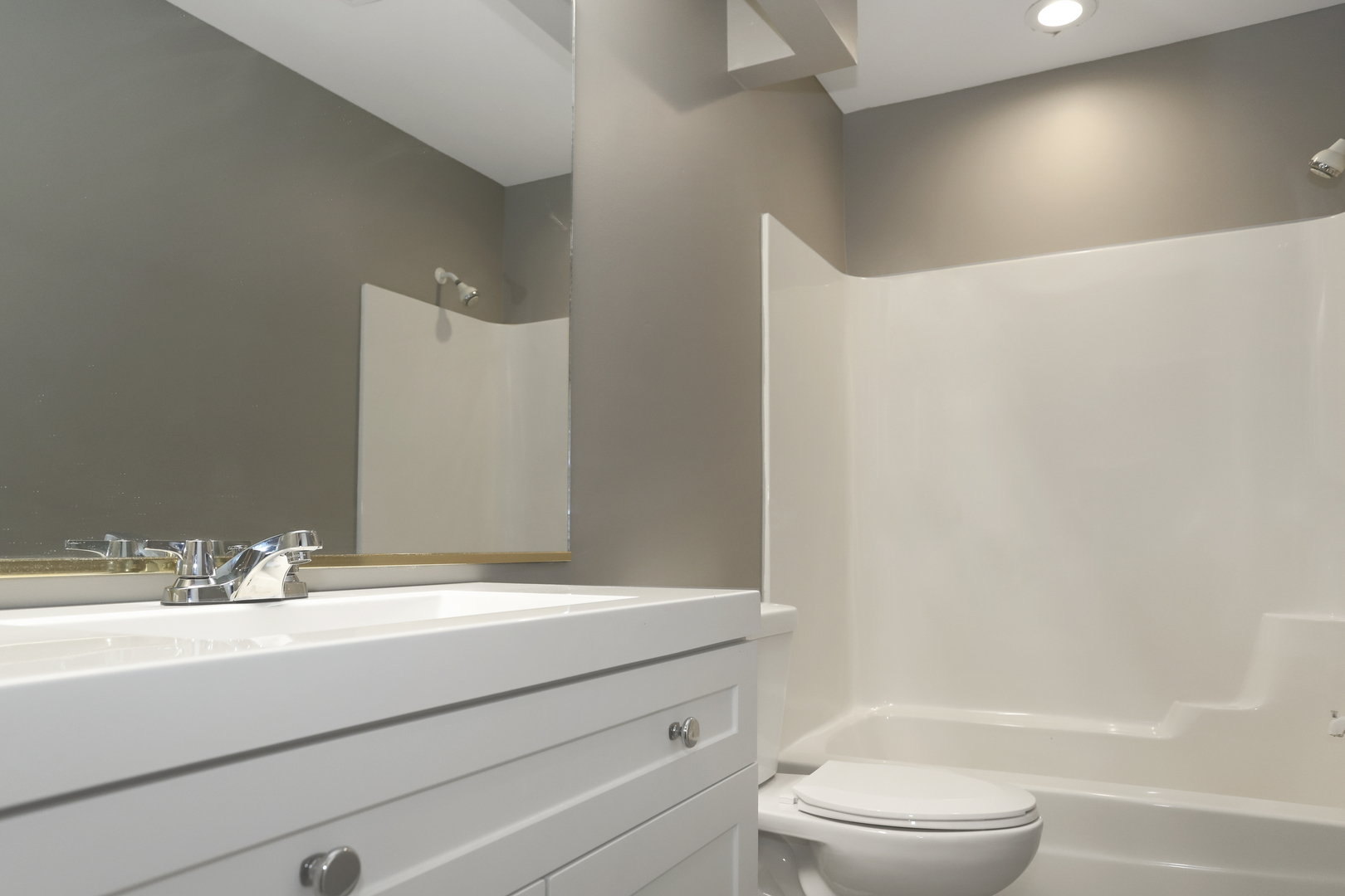 100 Ravinia Drive Shorewood, IL 60404 - Photo 29 of 33 a bathroom with a bathtub shower sink vanity and toilet