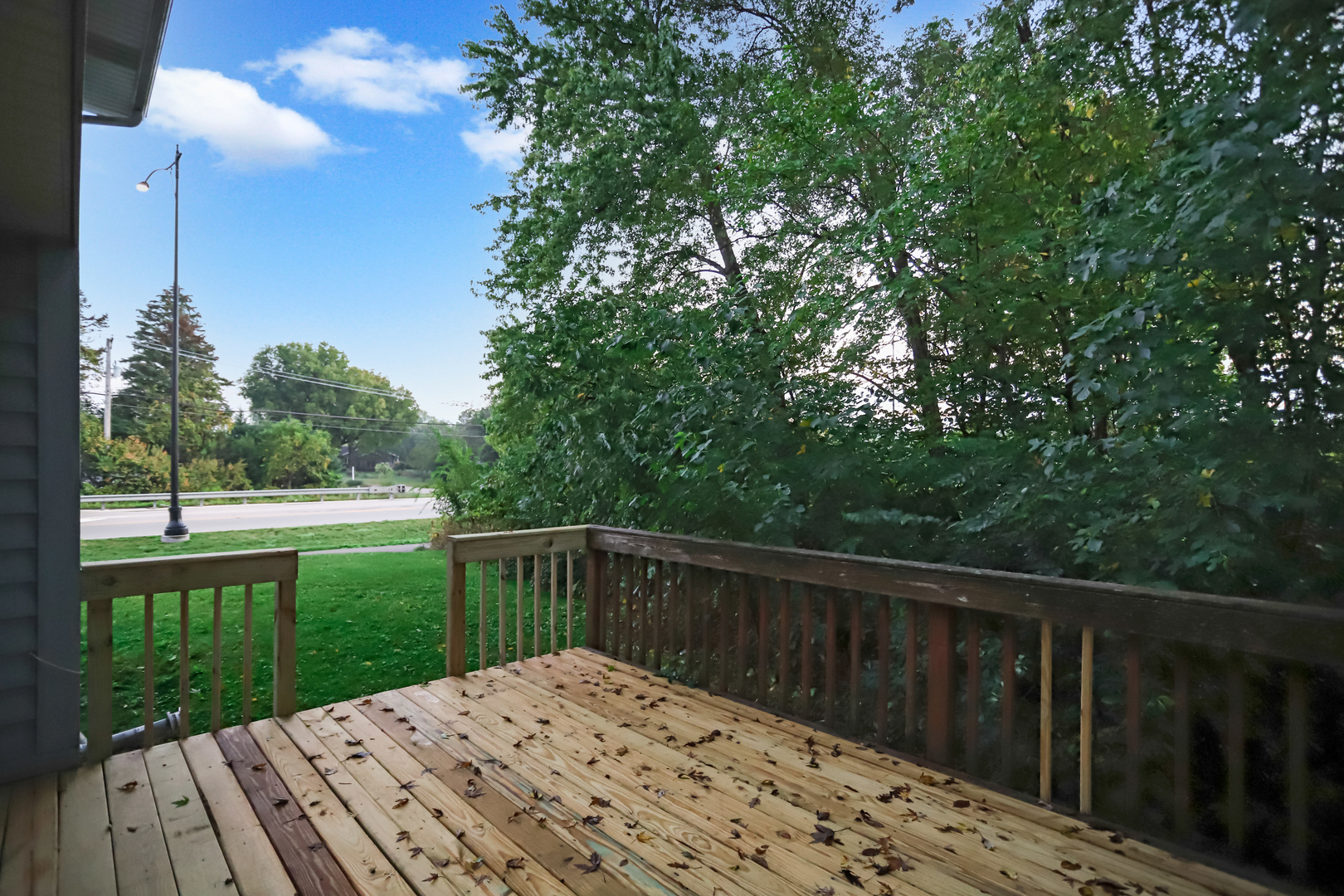 100 Ravinia Drive Shorewood, IL 60404 - Photo 32 of 33 a view of a wooden deck next to a yard