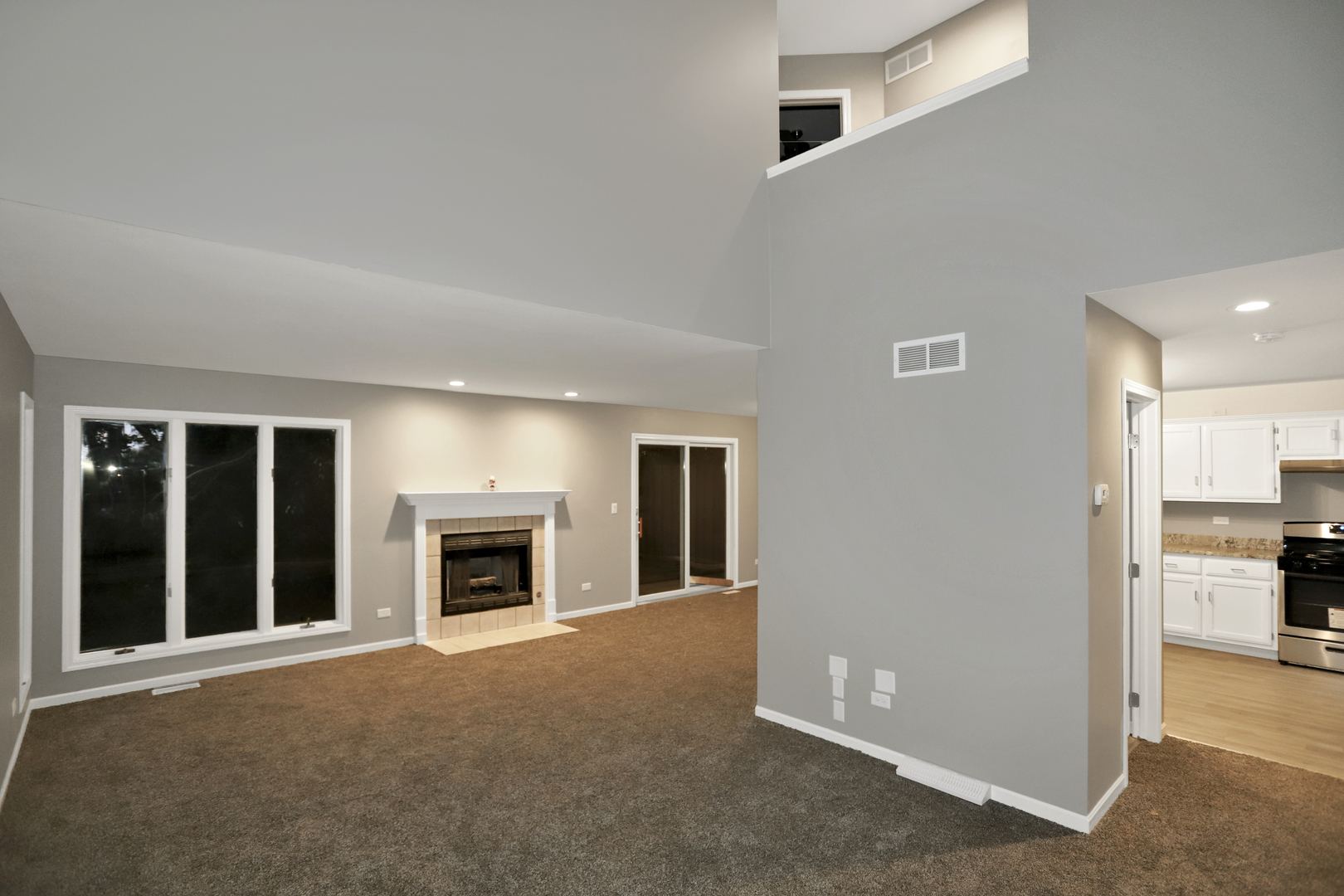 100 Ravinia Drive Shorewood, IL 60404 - Photo 7 of 33 a view of a livingroom with an empty space and a fireplace