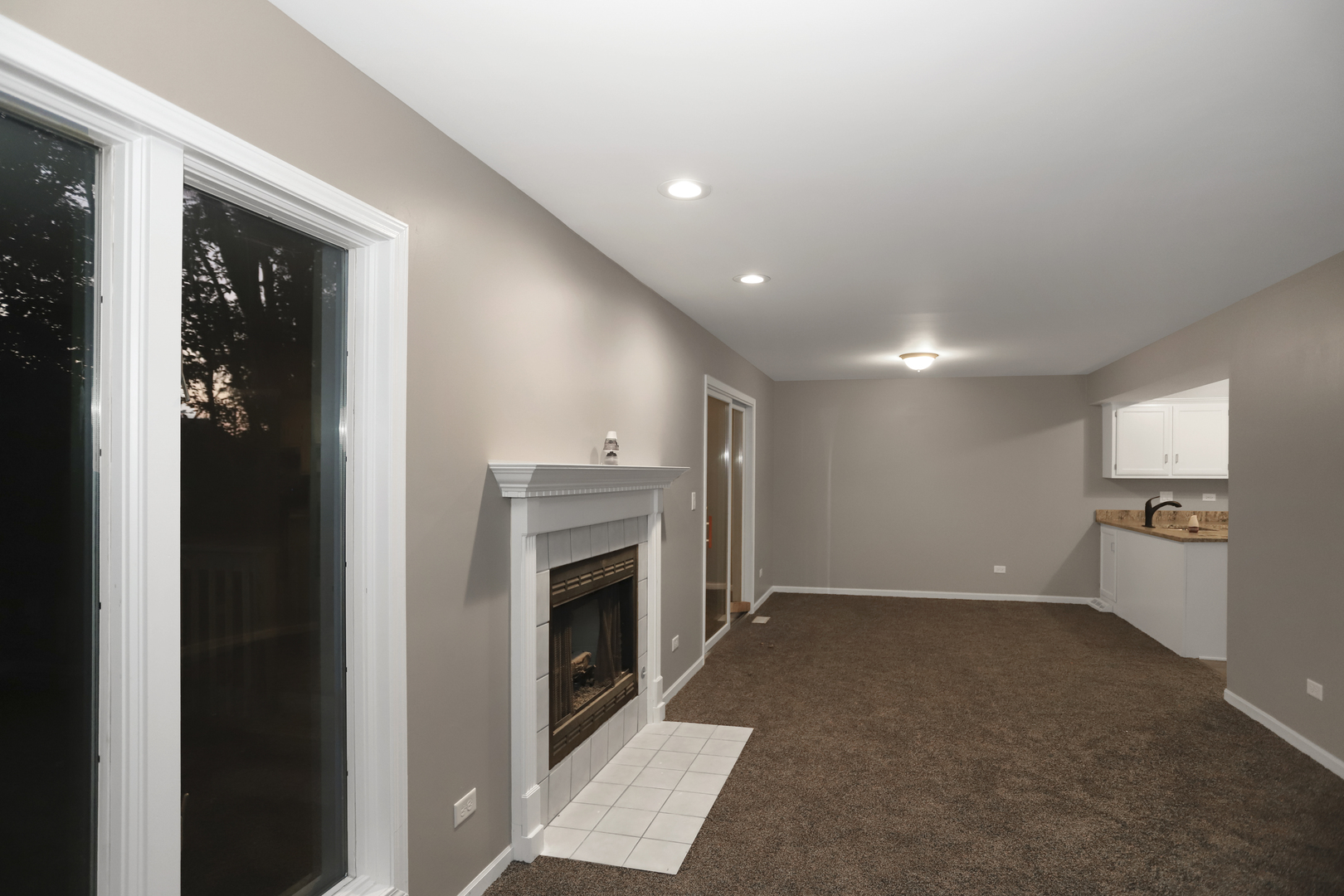 100 Ravinia Drive Shorewood, IL 60404 - Photo 9 of 33 an empty room with windows and fireplace