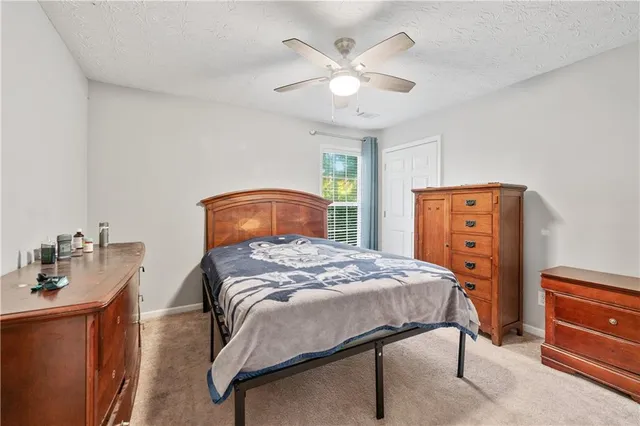 a bedroom with a bed and a dresser