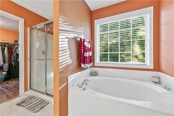 a bathroom with a bathtub and a shower