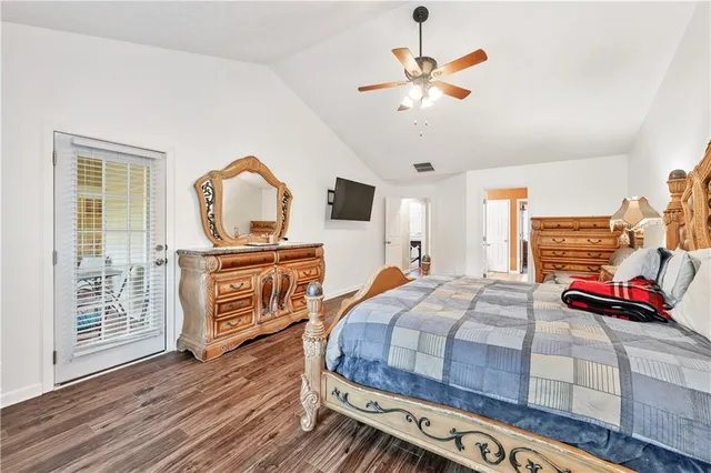 a bedroom with bed and wooden floor