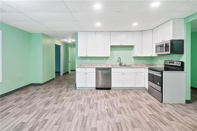 a kitchen with a sink stove and cabinets