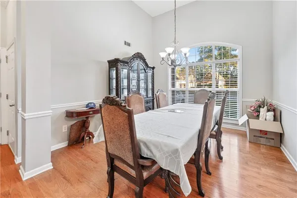 a view of a dining room with furniture wooden floor and chandelier