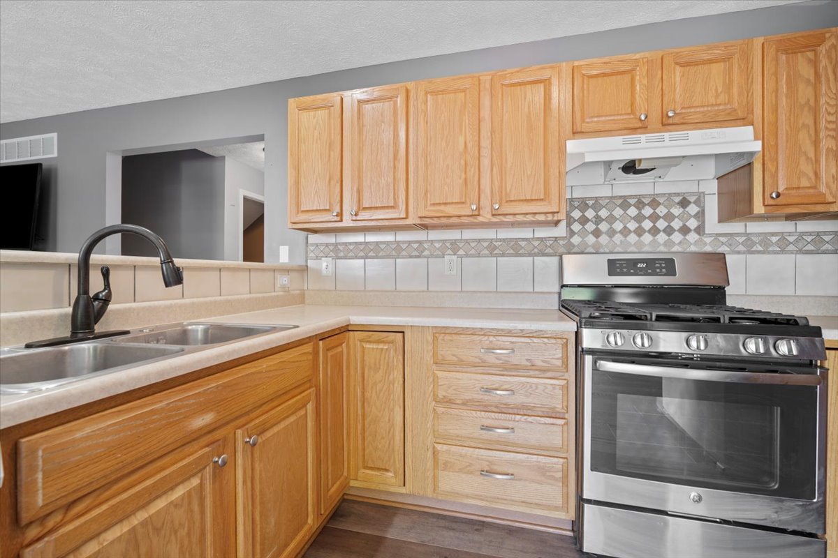 1704 Sunrise Point Normal, IL 61761 - Photo 11 of 33 a kitchen with granite countertop a sink stove and cabinets