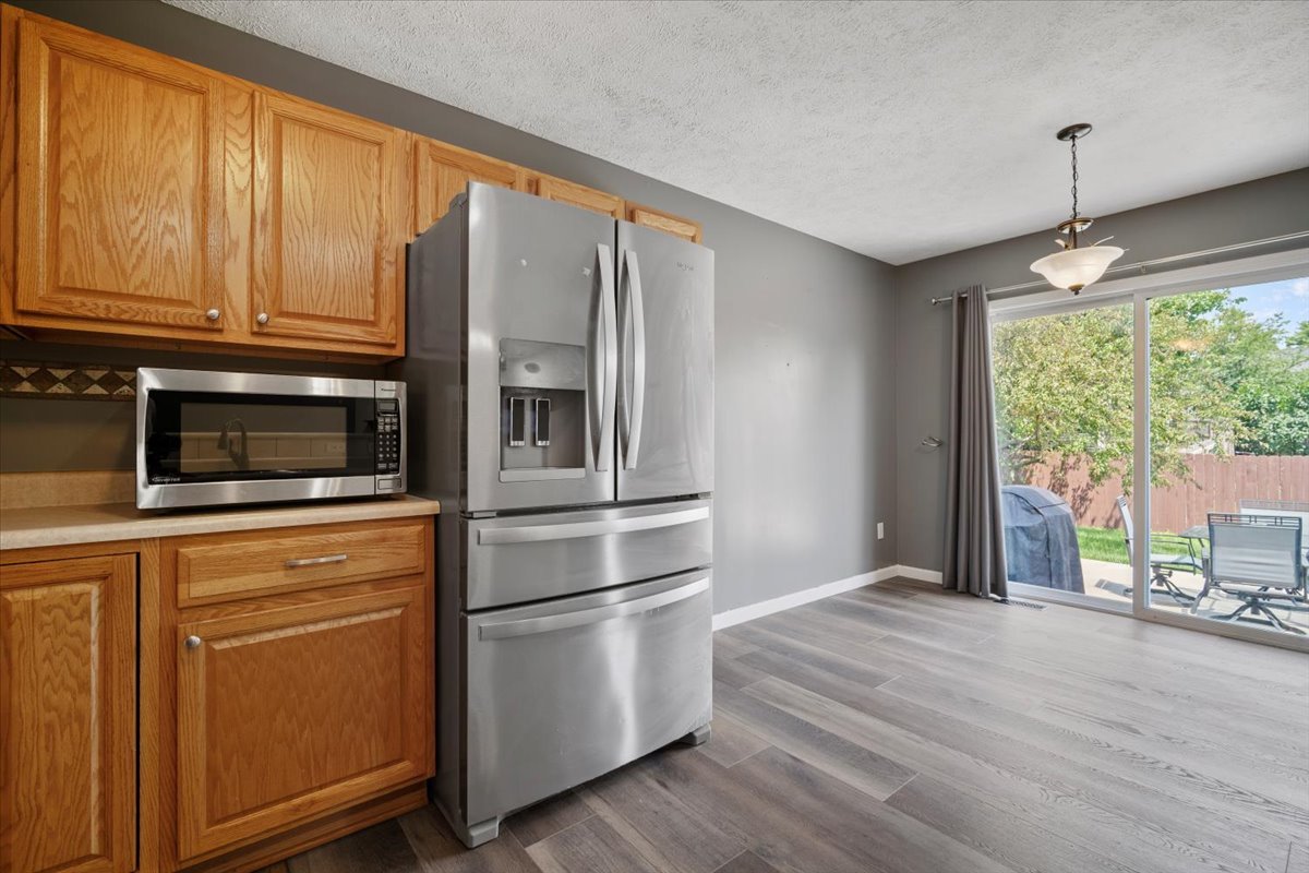 1704 Sunrise Point Normal, IL 61761 - Photo 12 of 33 a kitchen with stainless steel appliances granite countertop a refrigerator and microwave
