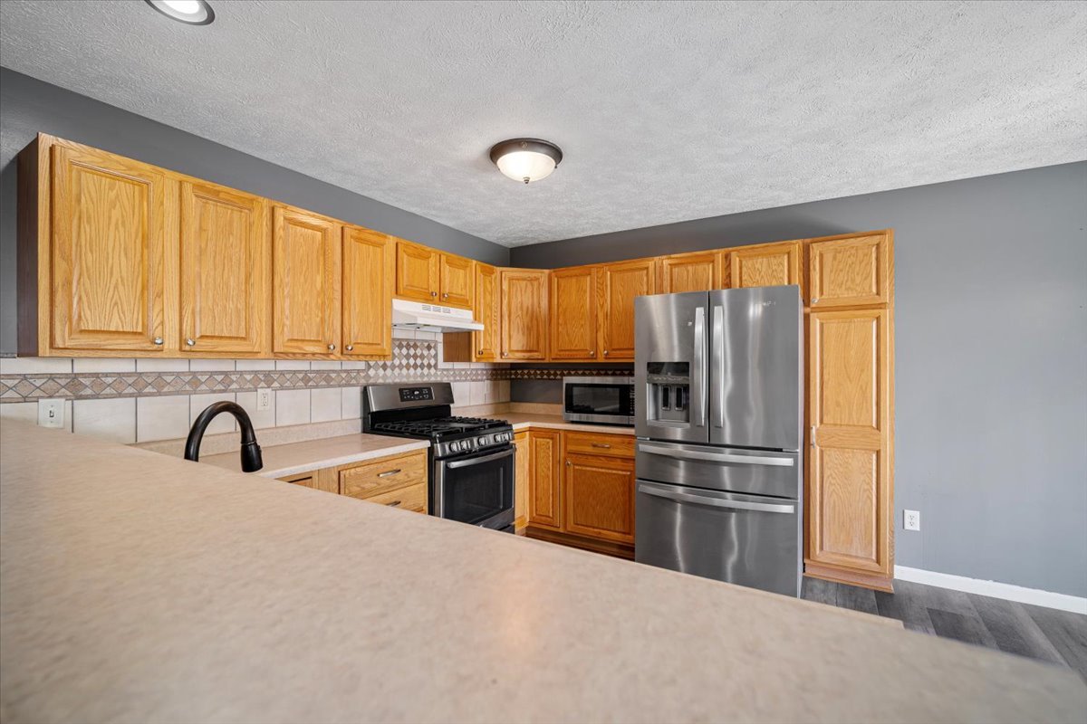 1704 Sunrise Point Normal, IL 61761 - Photo 23 of 33 a kitchen with stainless steel appliances granite countertop a refrigerator sink and cabinets