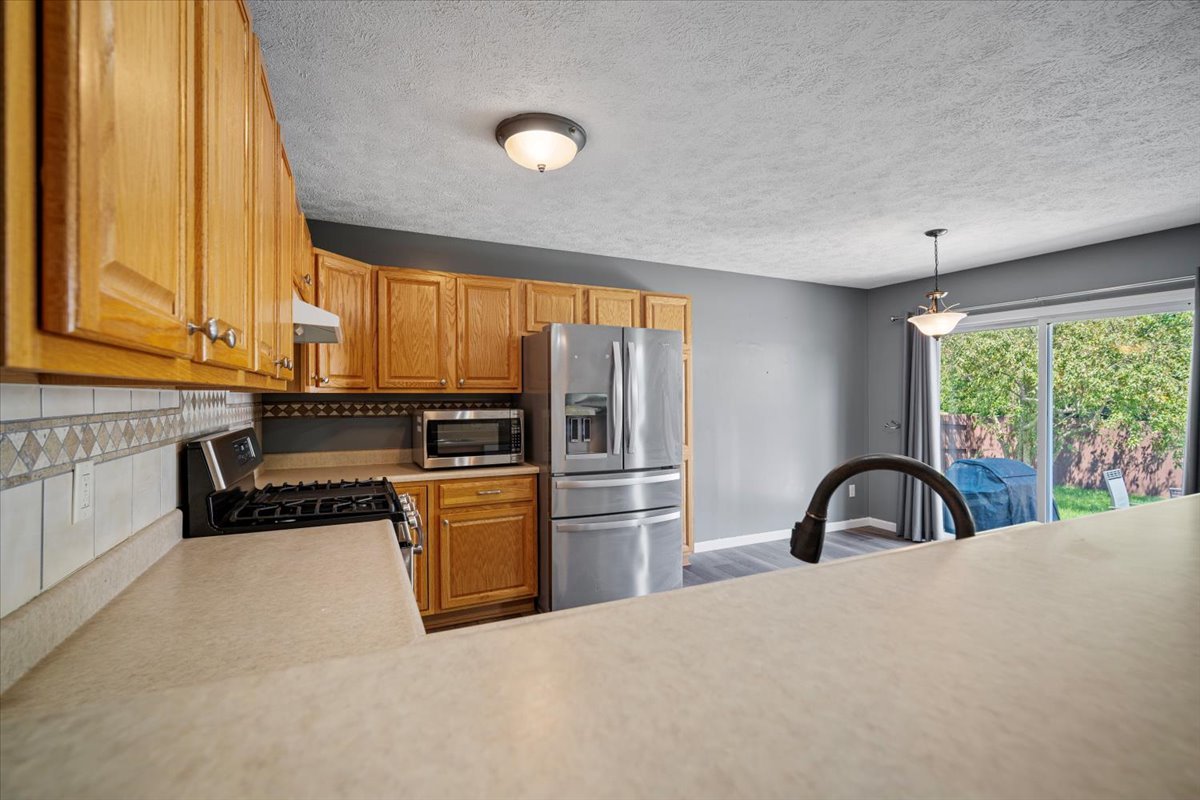 1704 Sunrise Point Normal, IL 61761 - Photo 24 of 33 a kitchen with granite countertop a stove and a refrigerator