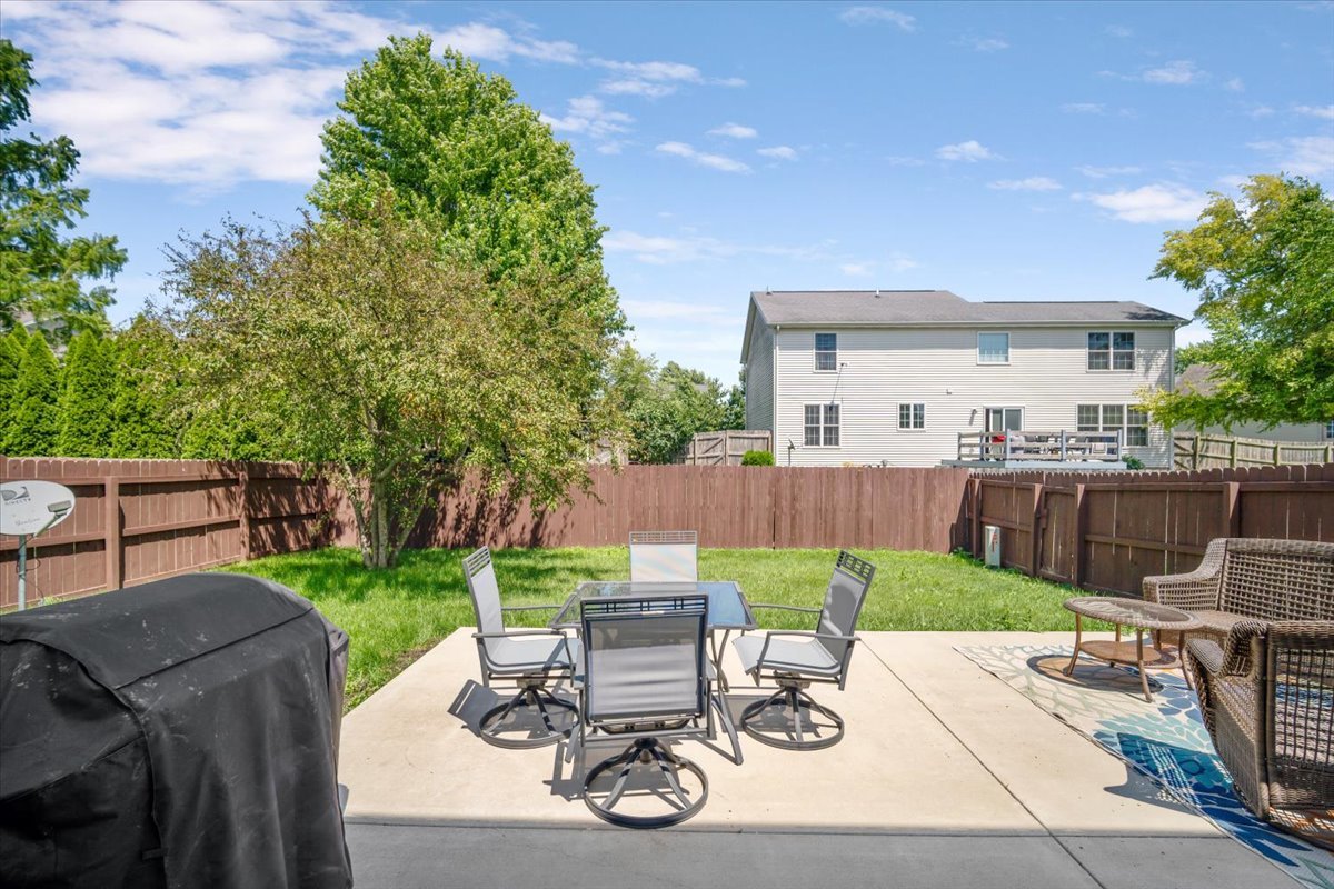 1704 Sunrise Point Normal, IL 61761 - Photo 28 of 33 a view of a patio with table and chairs potted plants and a large tree