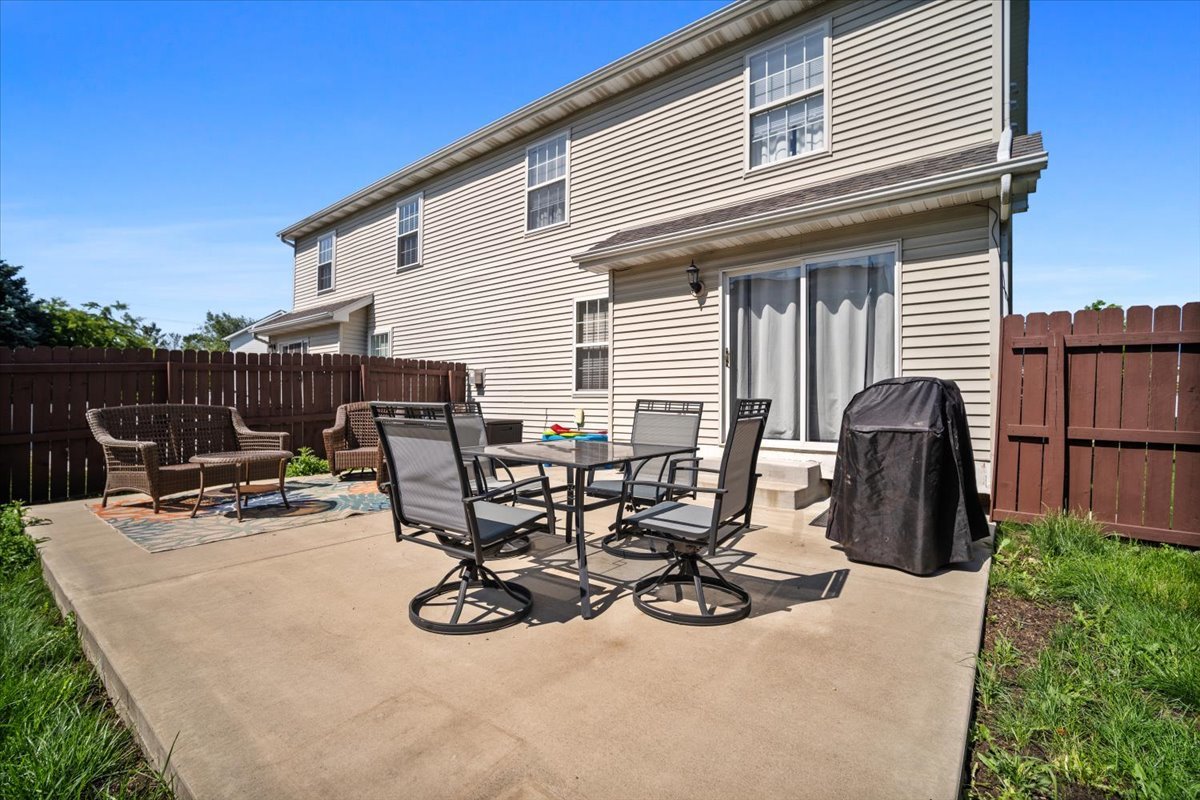 1704 Sunrise Point Normal, IL 61761 - Photo 29 of 33 a view of a patio with table and chairs and a barbeque