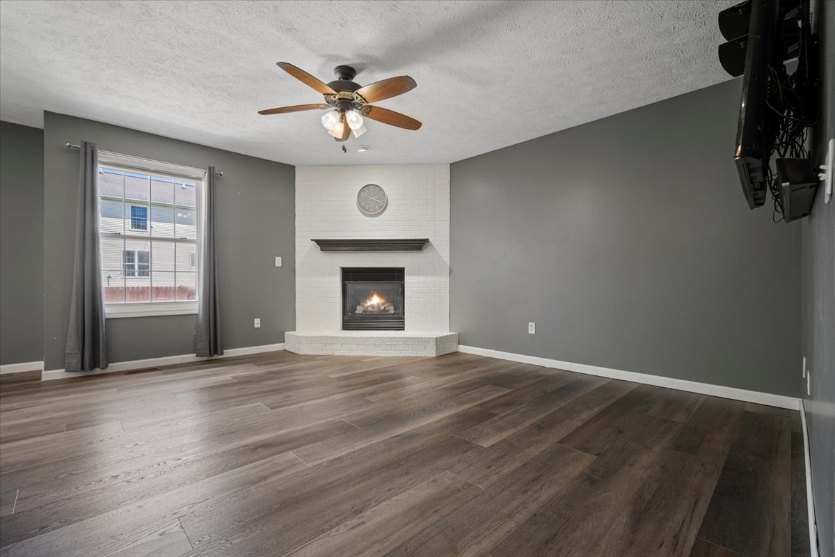 1704 Sunrise Point Normal, IL 61761 - Photo 3 of 33 an empty room with windows fireplace and fan