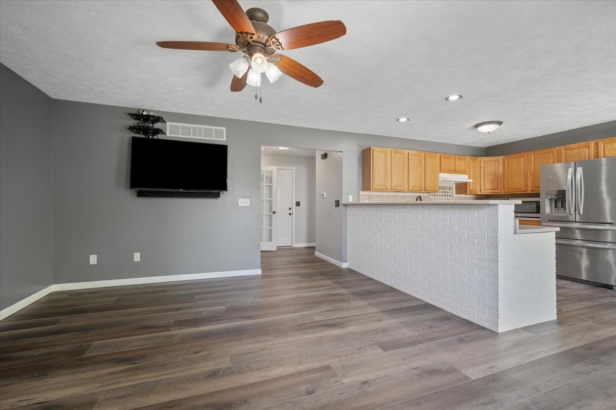 1704 Sunrise Point Normal, IL 61761 - Photo 5 of 33 a view of a kitchen with wooden floor and a ceiling fan